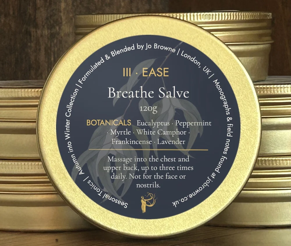 Breathe Salve in gold tins with navy band labels