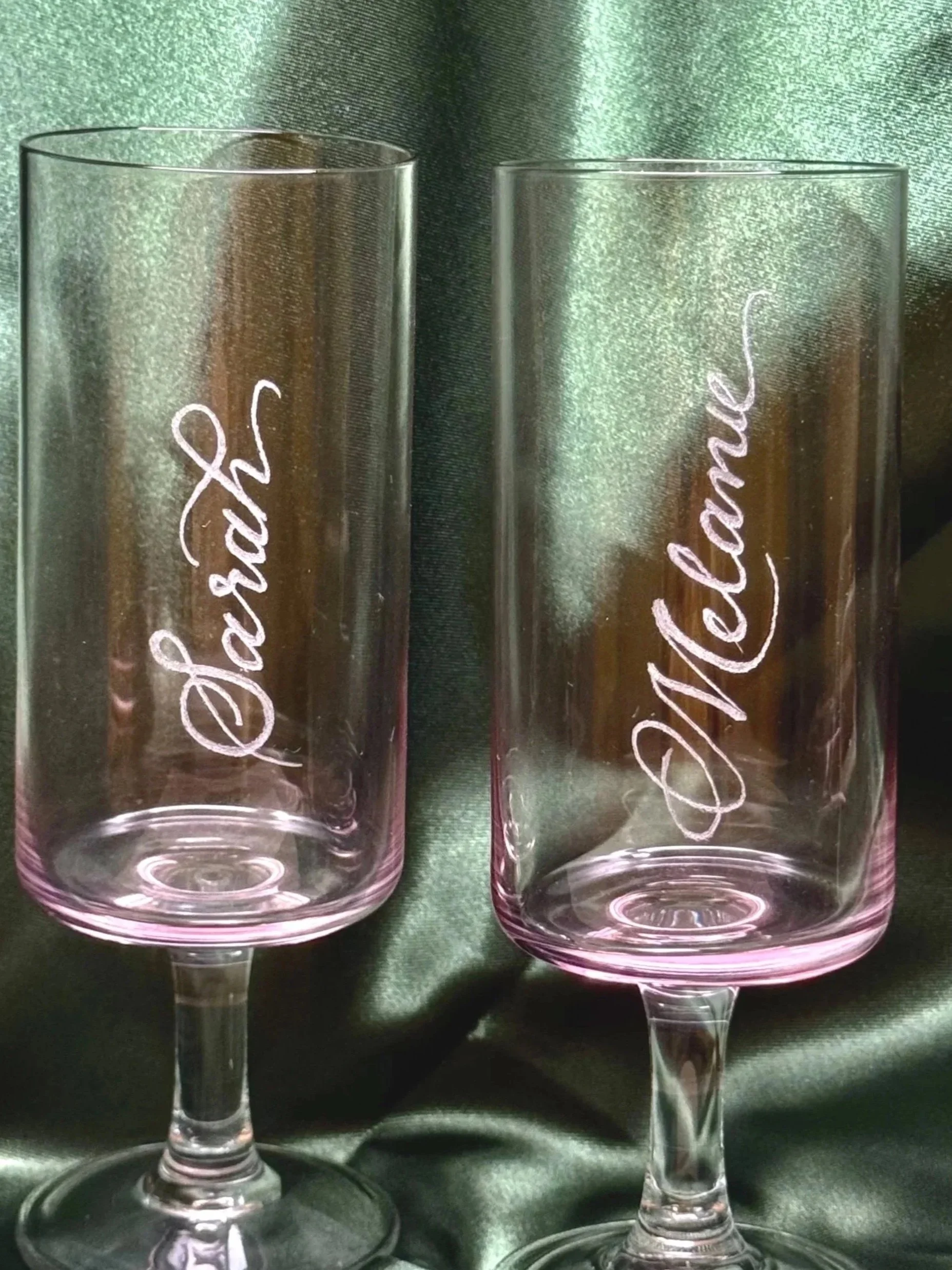 Calligraphy engraving on champagne flutes for brand activations and weddings.