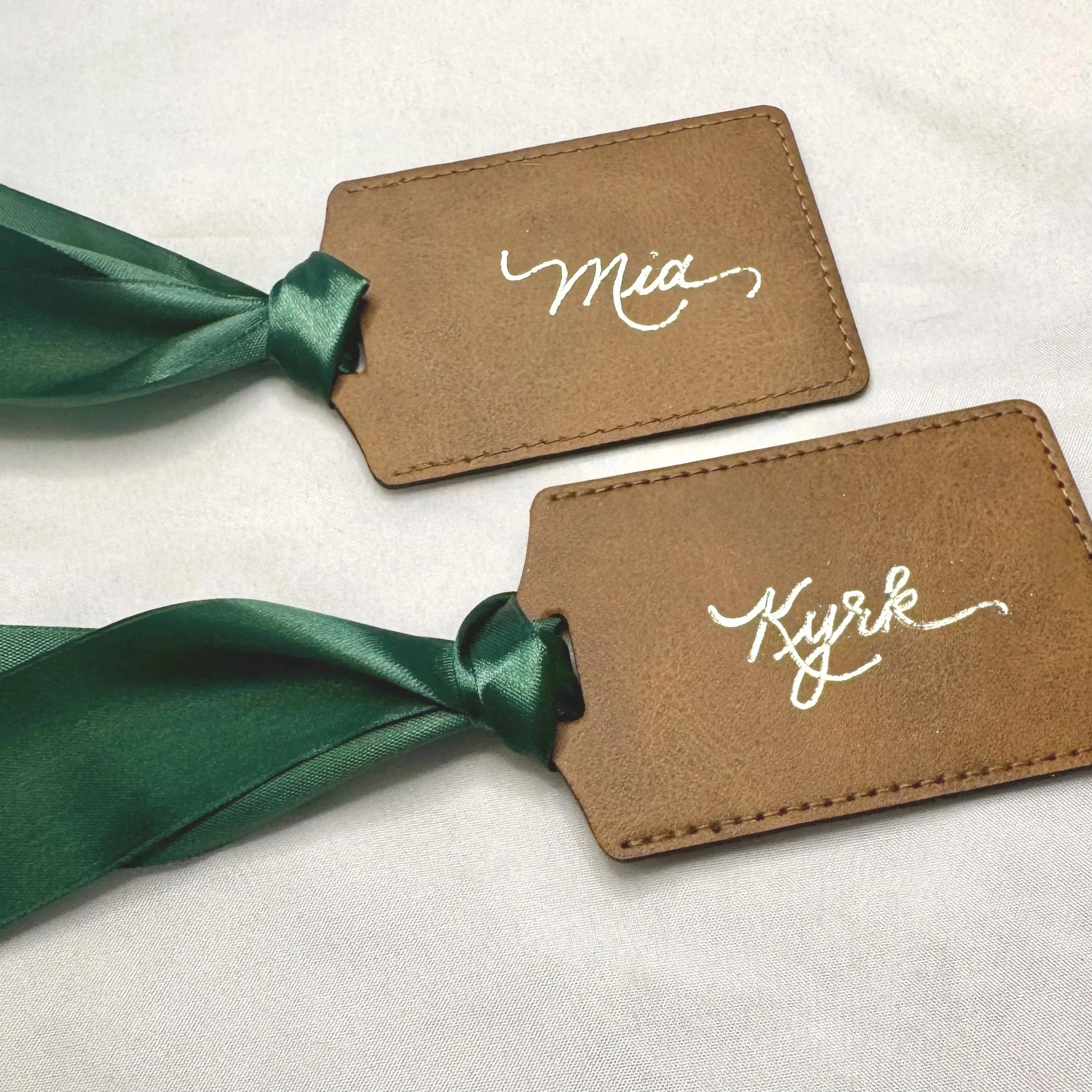 Gold calligraphy hot foiling on luggage tags.
