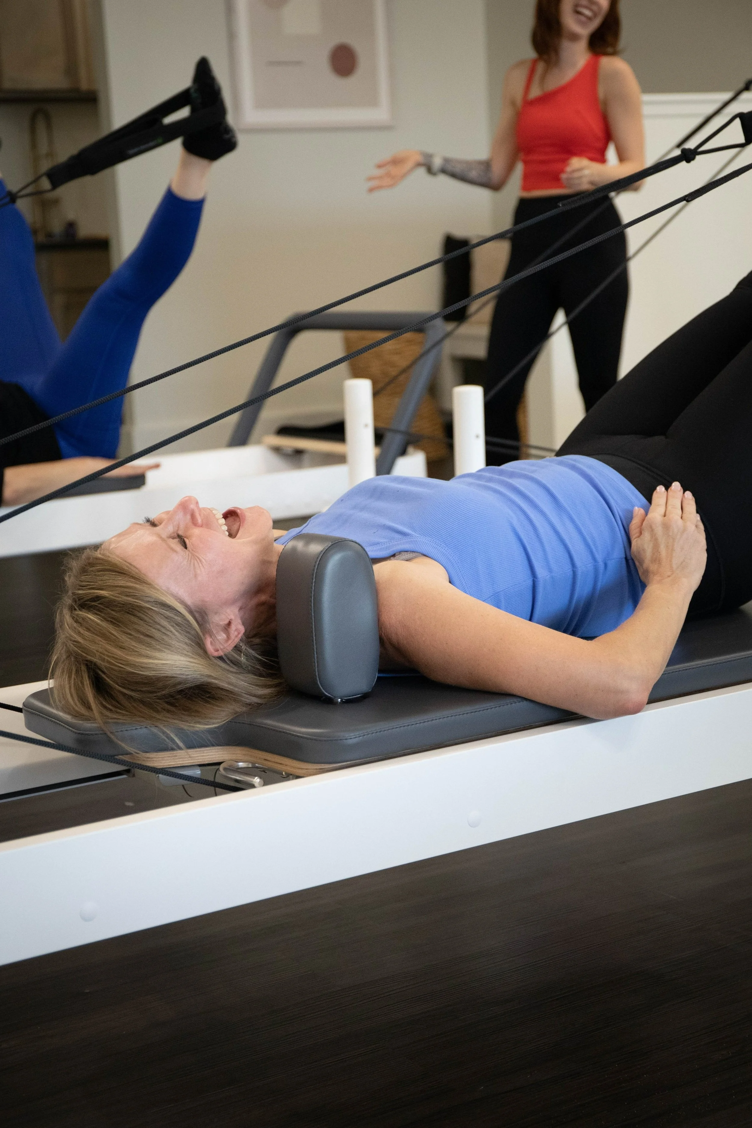 happy client doing reformer pilates