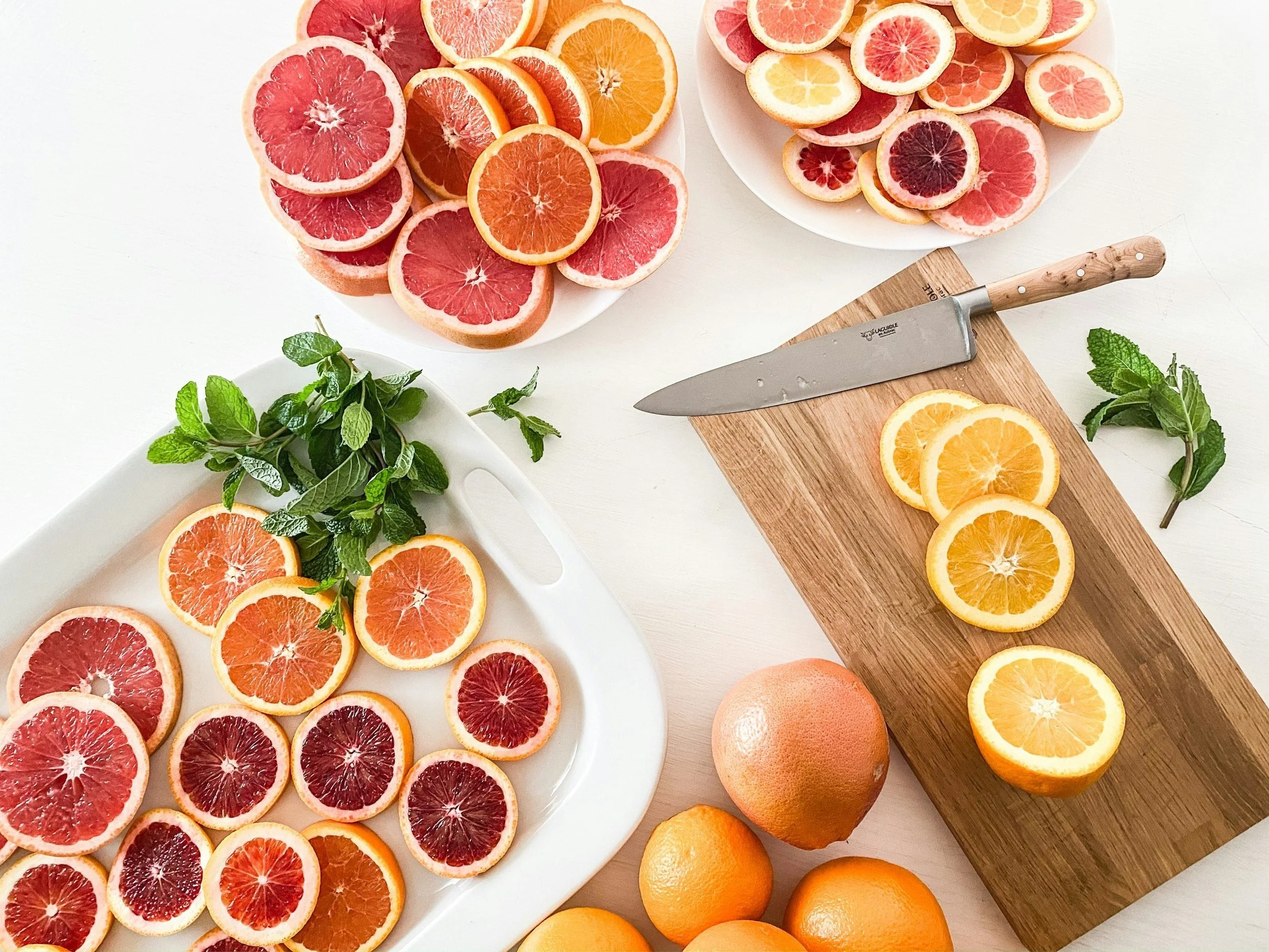 Assorted citrus fruits including grapefruits, oranges, and lemons, rich in vitamin C and beneficial for immune support and gum health.