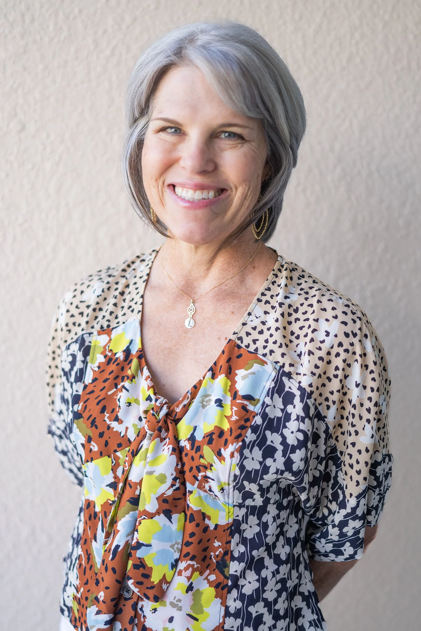 Lisa, leadership coach and HR consultant, smiling warmly in a professional portrait.