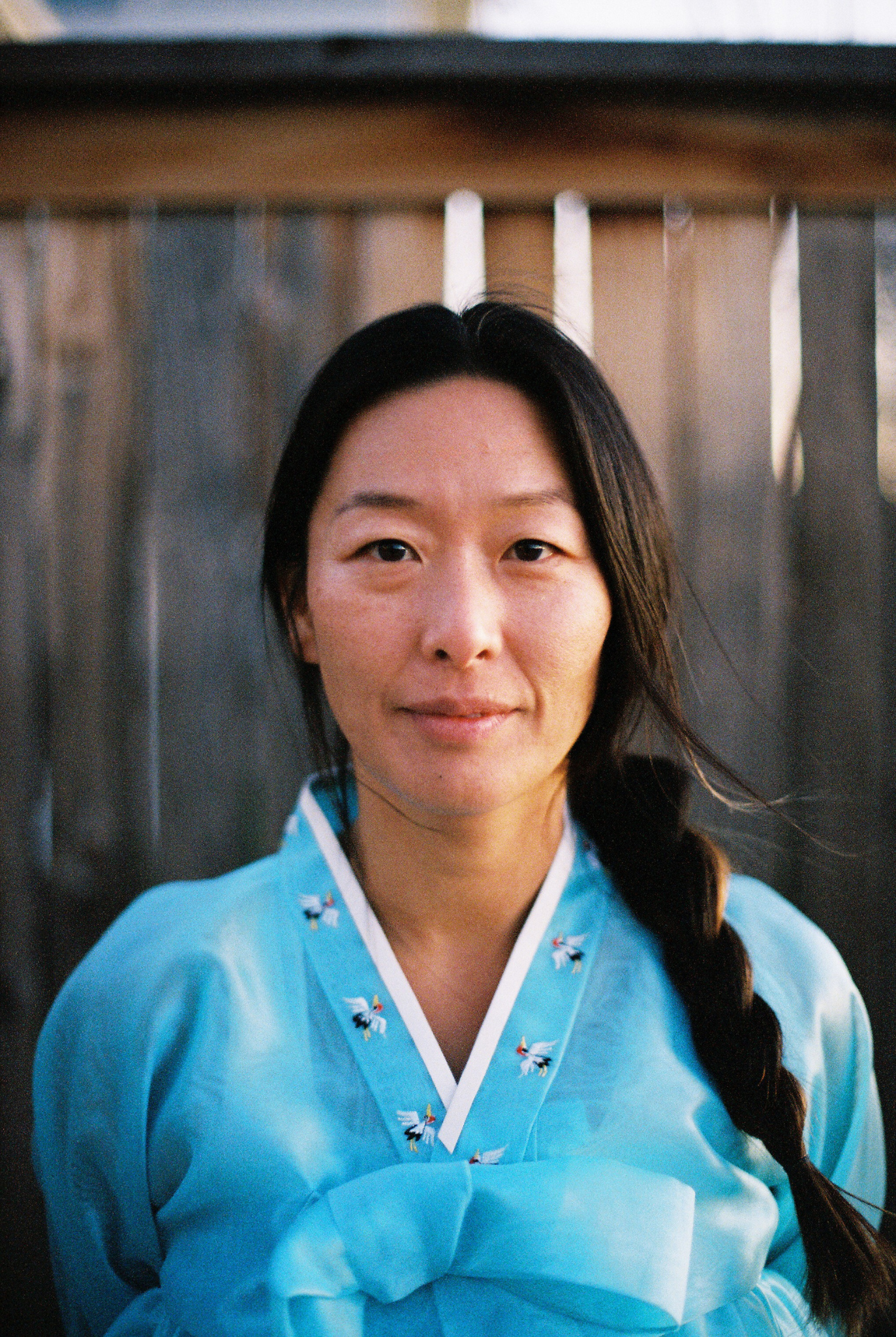 Portrait of Hannah Abuzaineh, creator of Here with Han, a creative practice exploring Korean American identity, memory, and belonging through photography and storytelling.