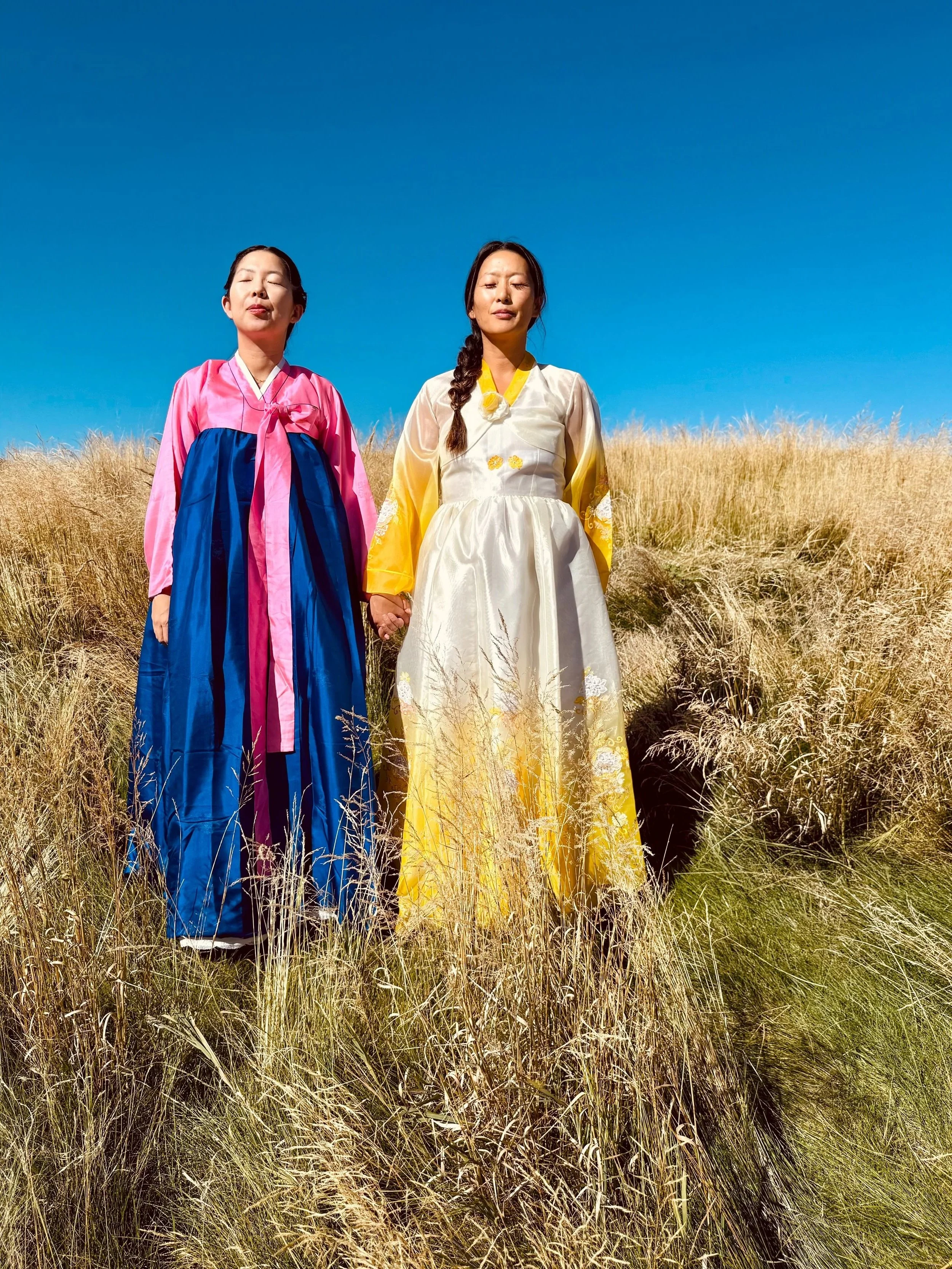 Portrait of Hannah Abuzaineh and Grace Kim standing beside an older woman in traditional Korean hanbok for In Time, a Here with Han photo essay exploring family, ancestry, and cultural identity.
