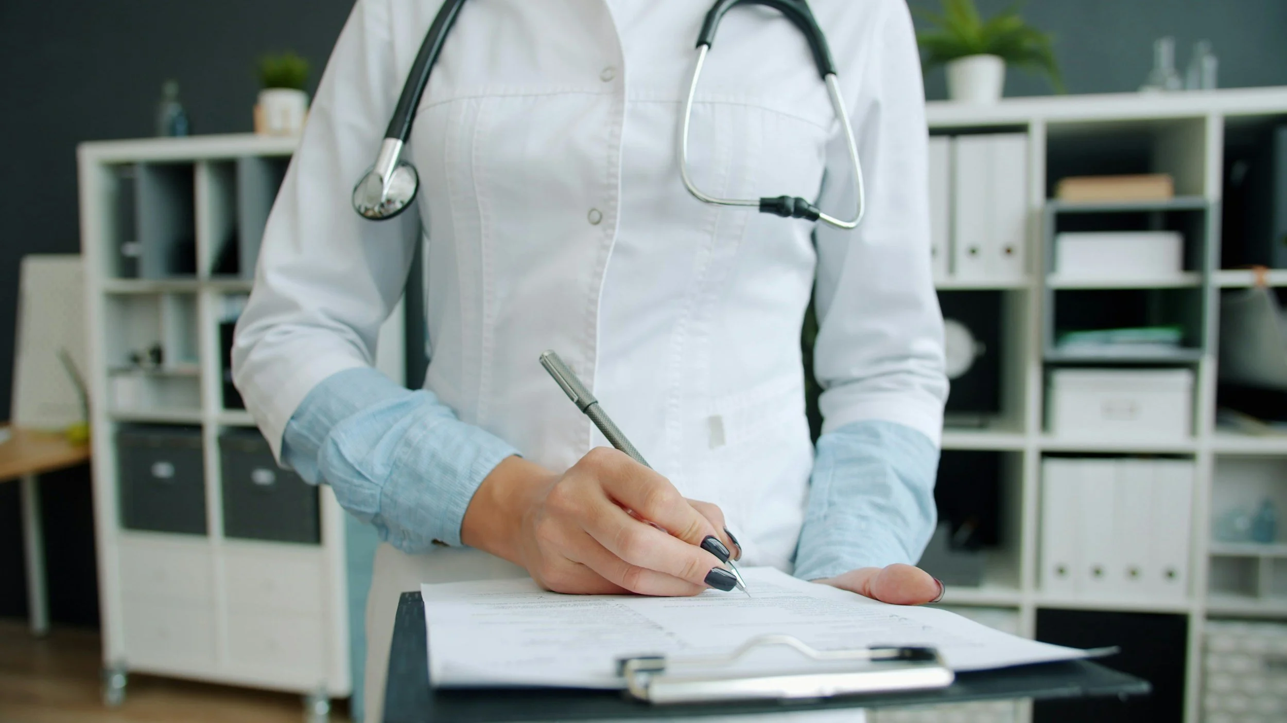 Doctor reviewing a patient file, representing health anxiety and uncertainty around medical information.