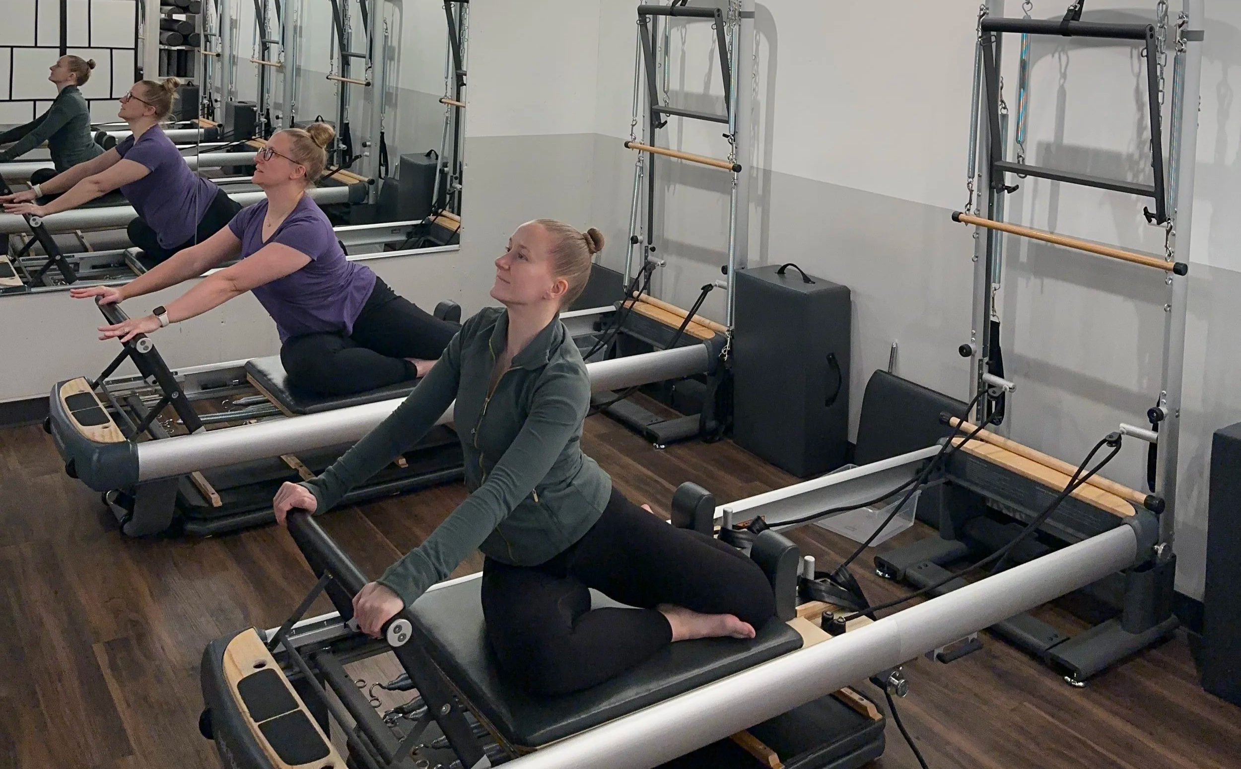 Group Pilates Reformer session focused on core strength, flexibility, and posture in a modern fitness studio.