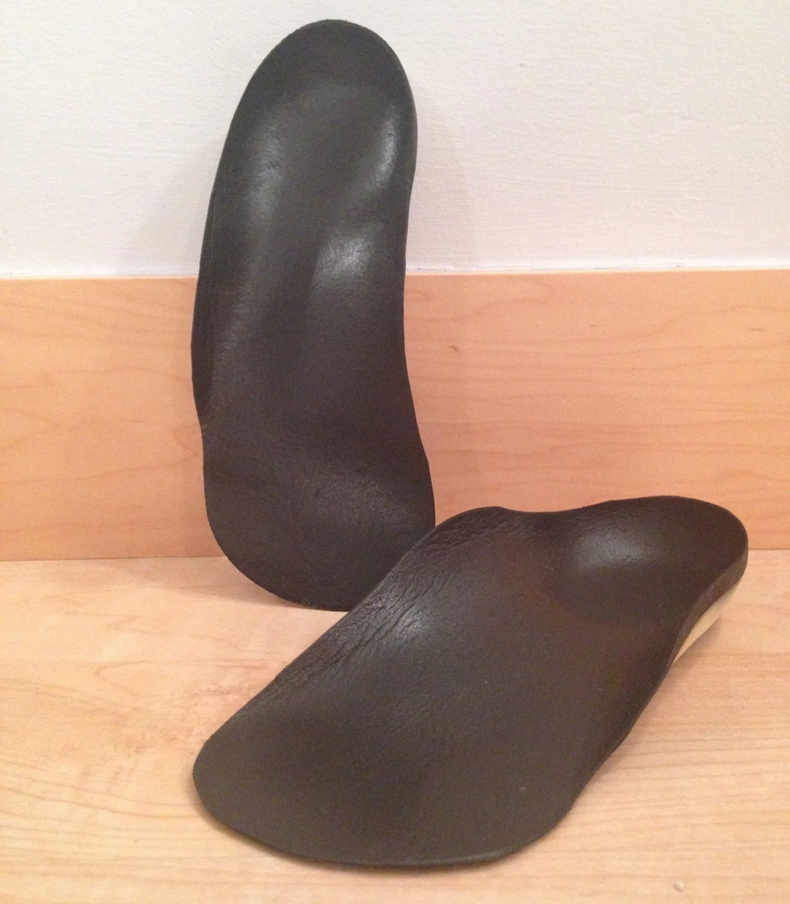In this photo you see black custom orthotics ordered by and approved by Dr. Sarah Petrich. Have a Educated PT Physical therapist look at your orthotics to make sure they are the right fit for you and your foot heath. My feet want these!