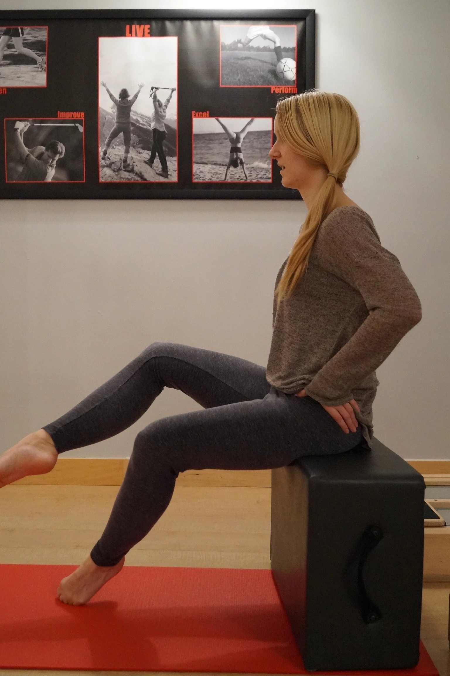 Dancer performing a controlled chair exercise emphasizing turnout, balance, and alignment.