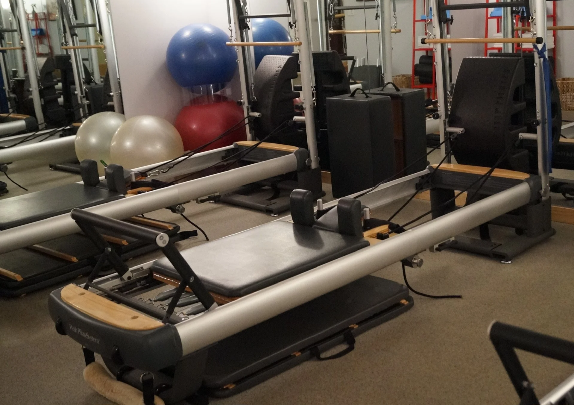 Pilates reformer used in physical therapy–informed Pilates for posture and movement education. Pilates reformer used for strength, mobility, and controlled movement training.