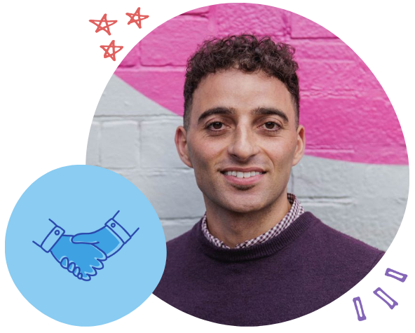 A man with short curly hair smiling at the camera, wearing a purple sweater over a checkered shirt, standing in front of a pink and white brick wall with a blue handshake icon and decorative stars and shapes around him.