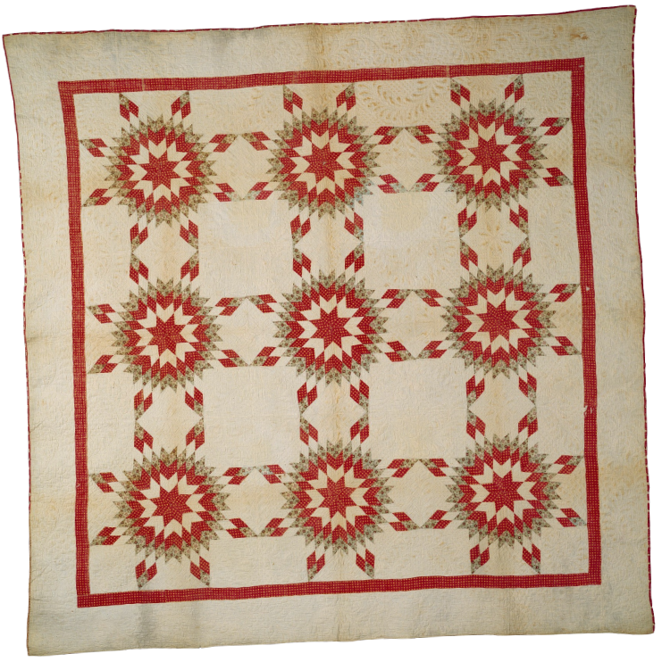 A quilt with a red, green, and cream star pattern and a red border.