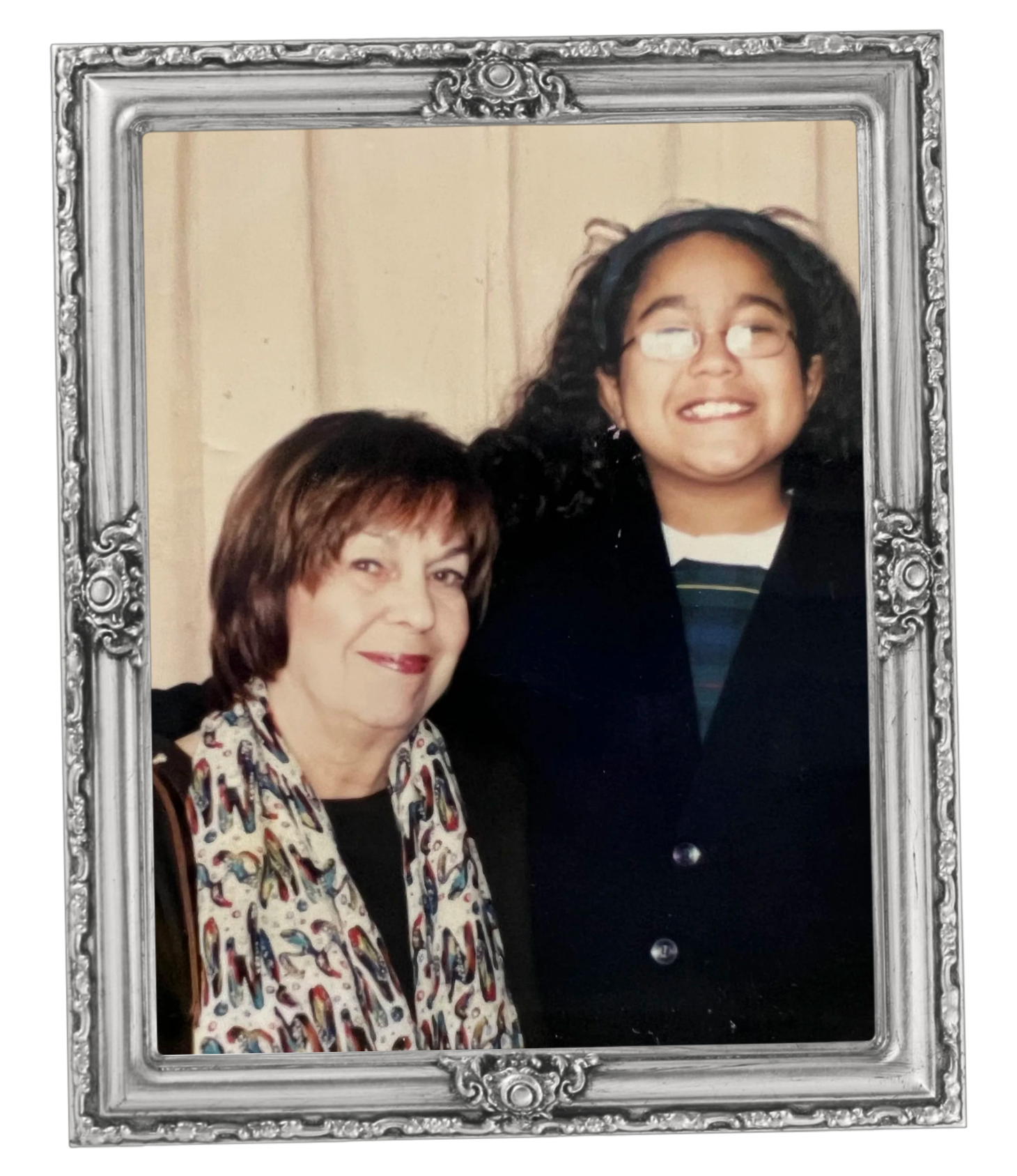 Chloe as a child and her grandmother Patricia smiling and posing together inside a decorative silver frame.