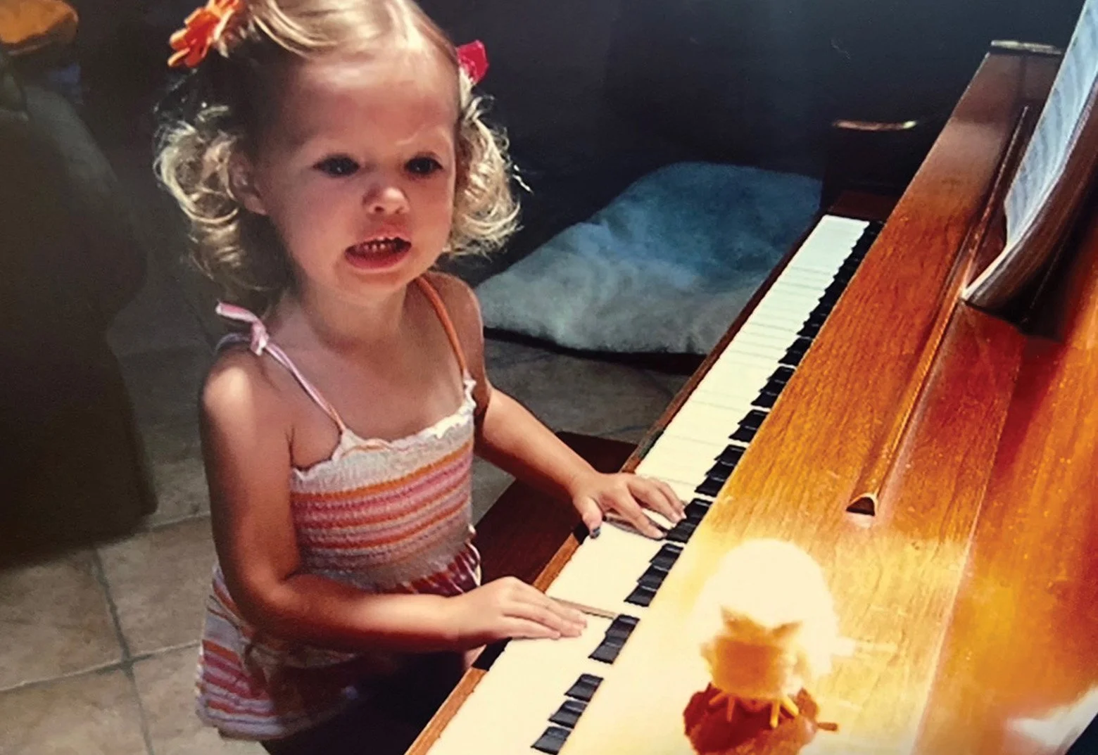 Kenedi at 3 years old sitting and singing at piano.jpg