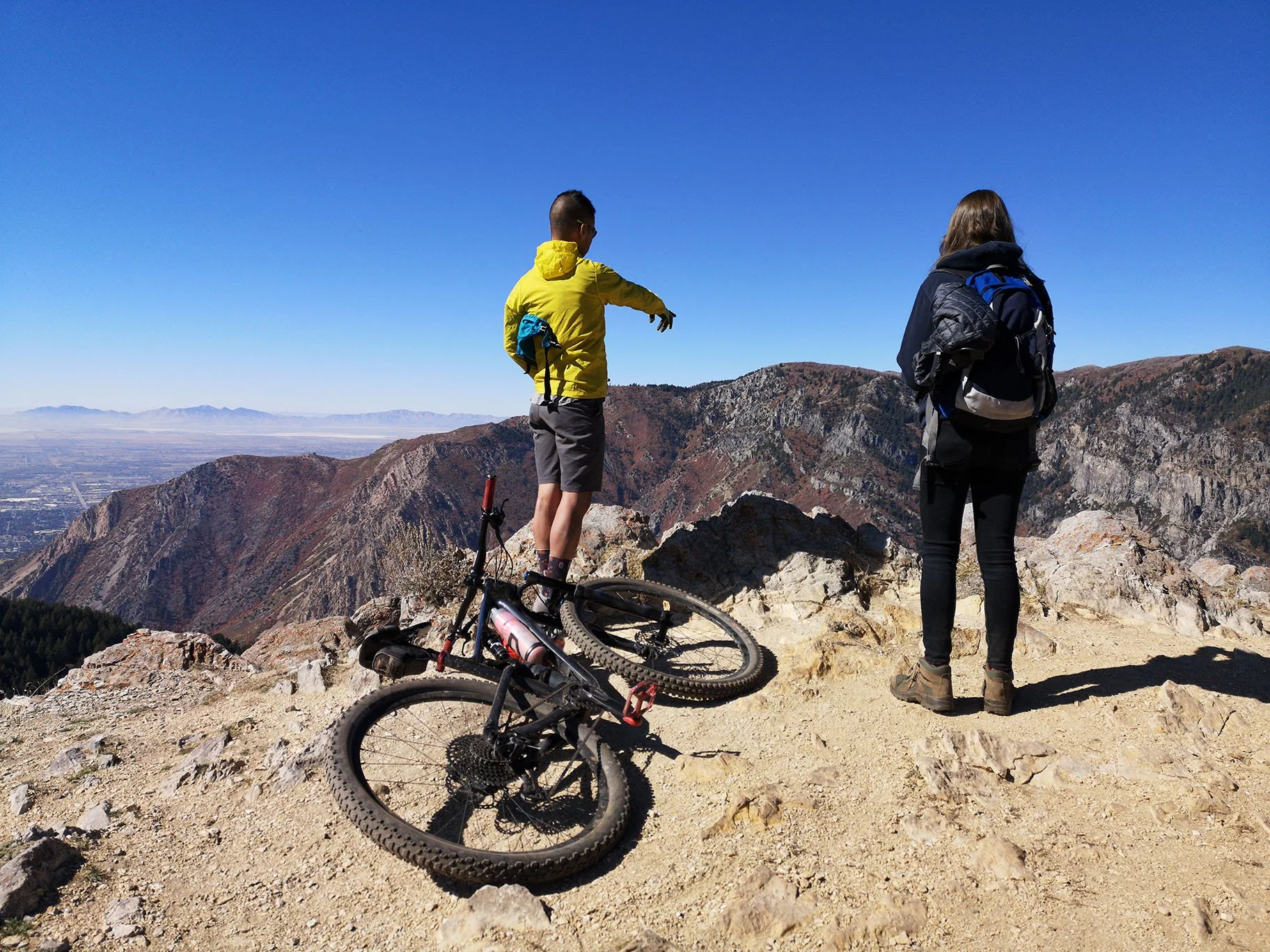 Mountain biker and hiker enjoying the view on the Sardine Peak trail near Snowbasin above Ogden, Utah