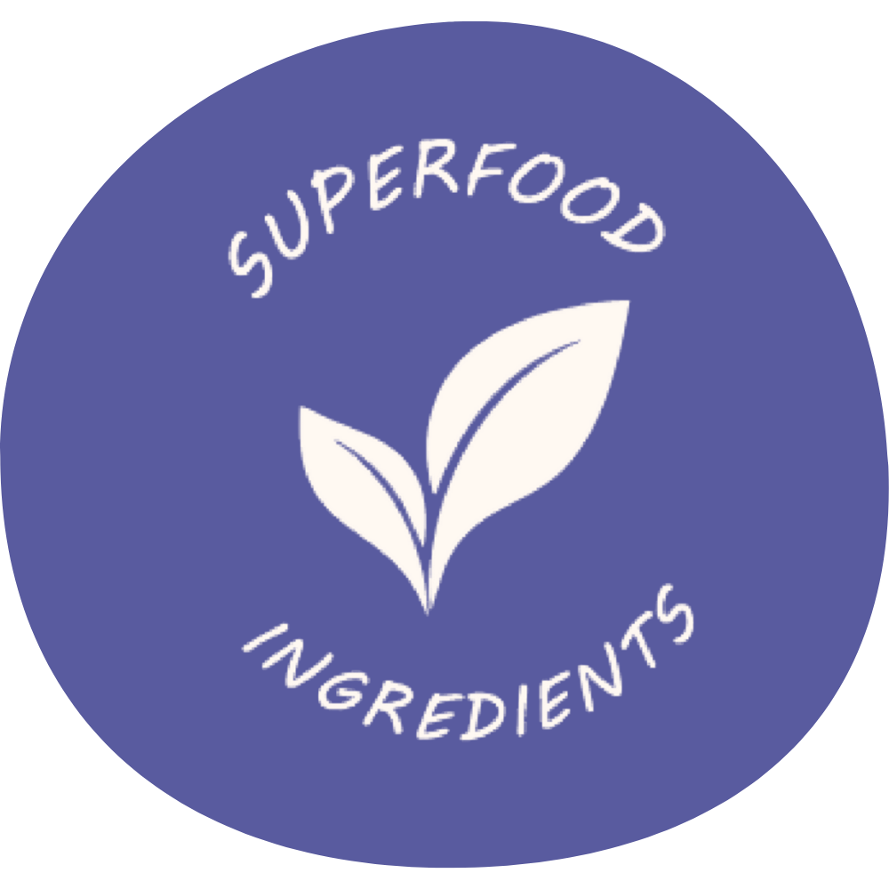 A label with a purple background featuring a white illustration of a plant with two leaves. The text 'SUPERFOOD INGREDIENTS' is written in white, curved around the plant.