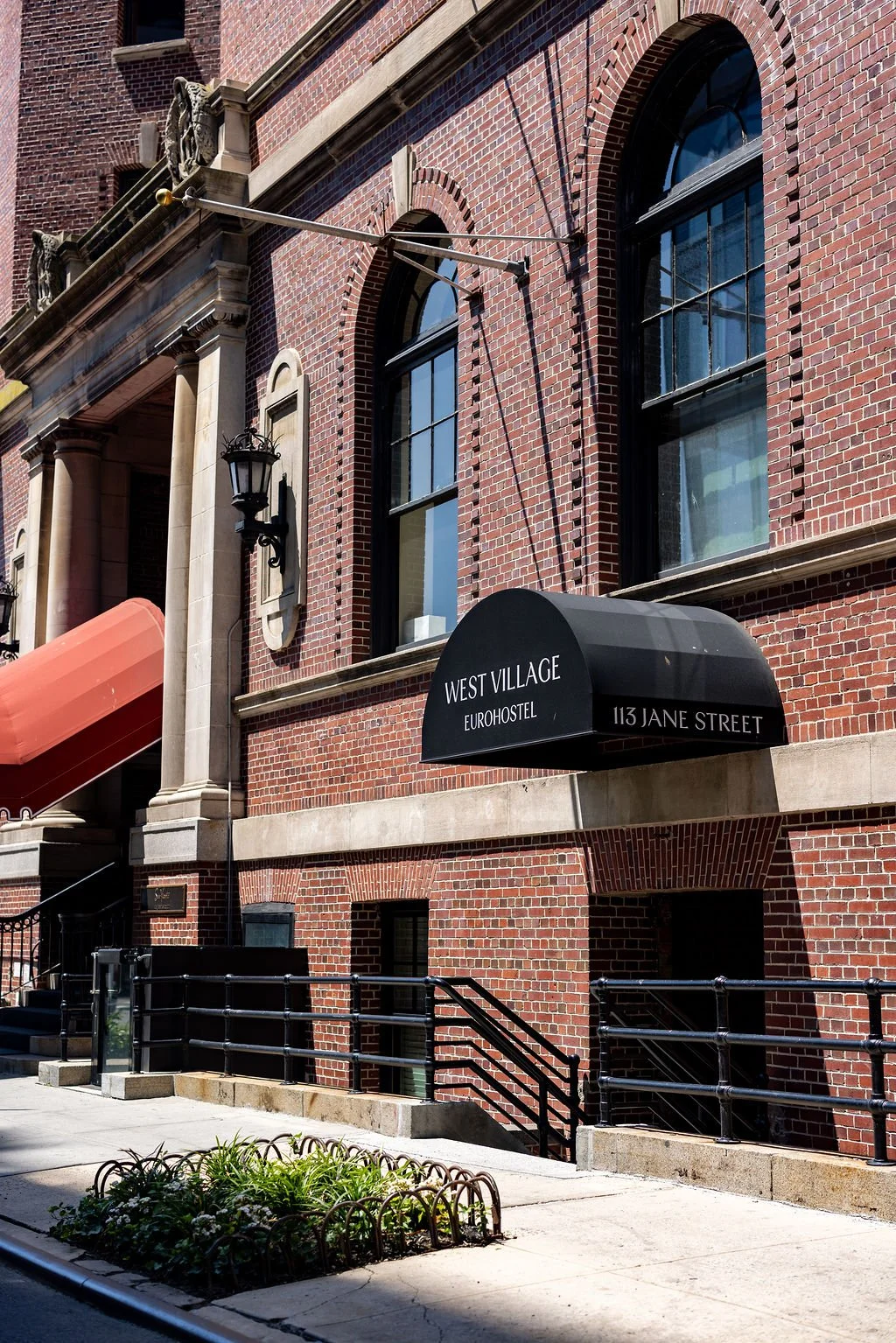 Building with brick facade and black awning that reads 'West Village Eurohostel 113 Jane Street'.