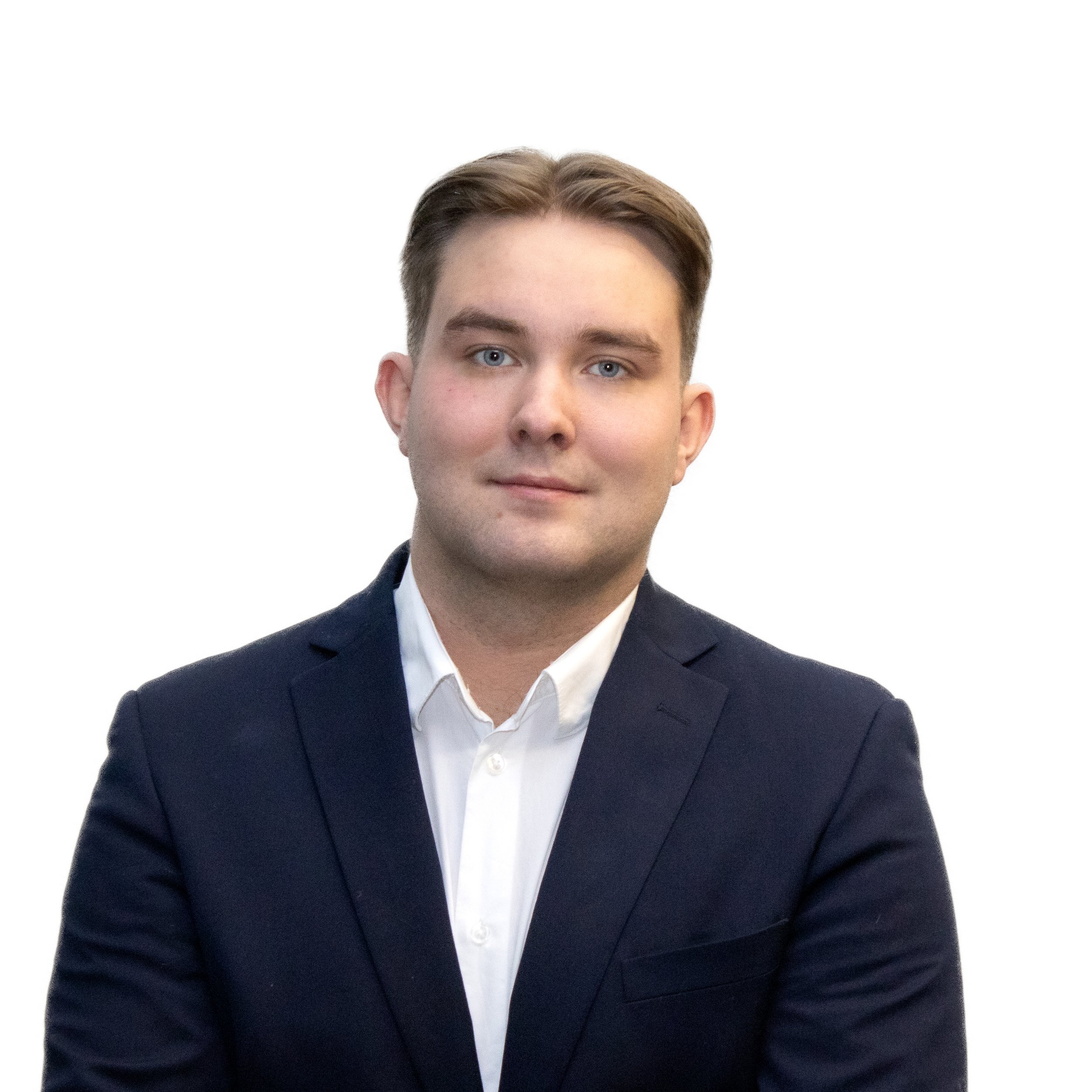 Headshot of a young man with light skin, brown hair, and blue eyes, wearing a dark suit jacket and white shirt, posing against a white background.