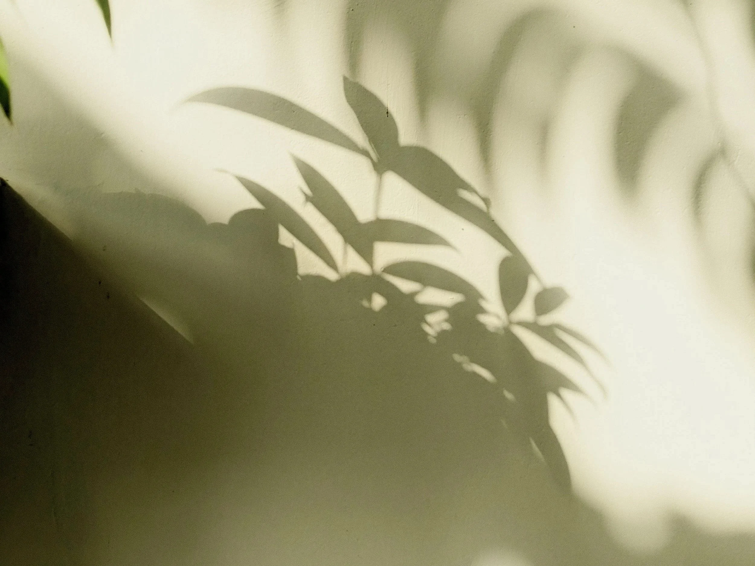 Close-up of a woman gripping a metal bar in a dark setting, emphasizing her hand and part of her arm with a focus on a tense grip.