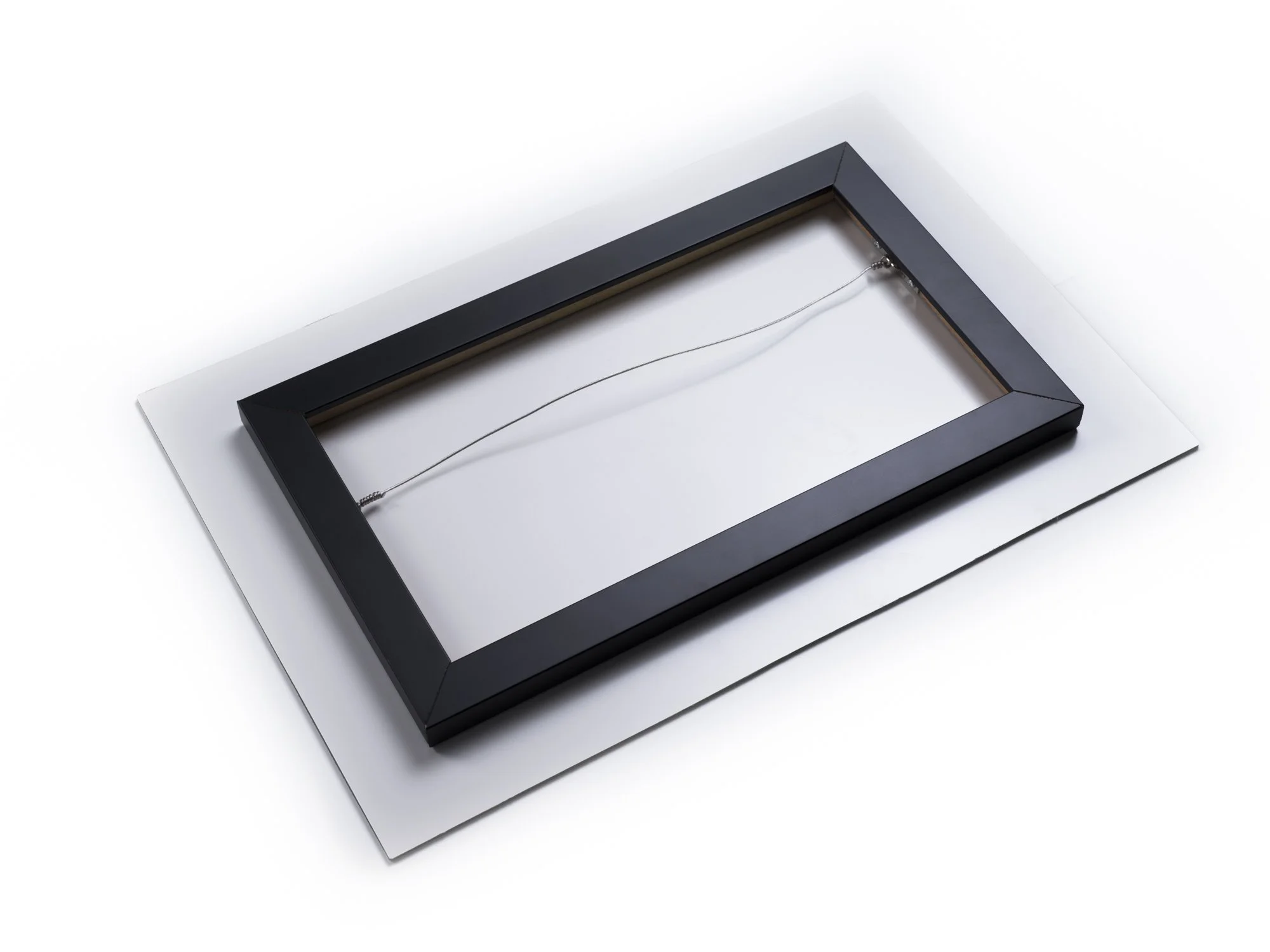 Black photo frame on a white background with a wire inside.