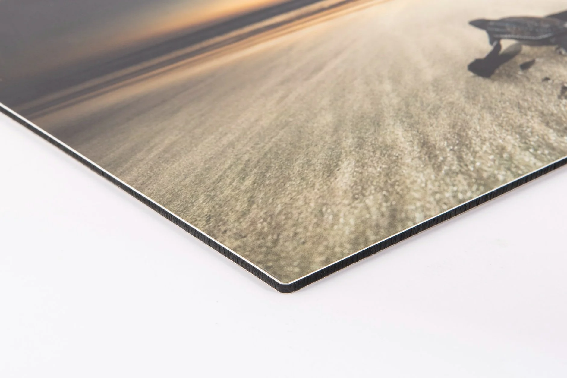 Close-up of a 3D printed surface with layered details and a photograph of a bench on a textured ground.