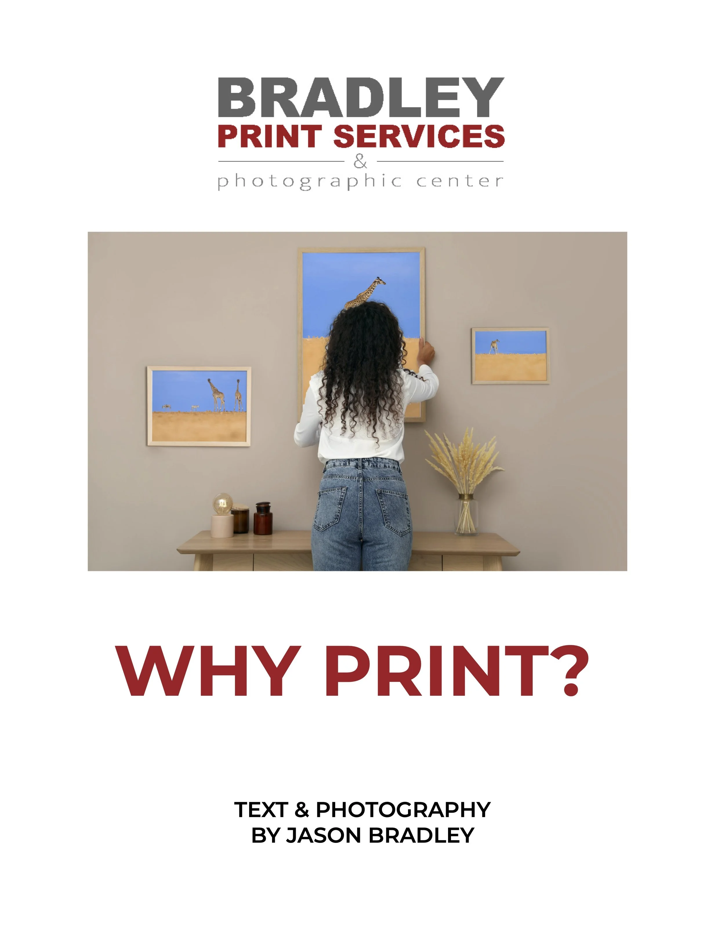 Book cover titled 'Why Print?' with a woman hanging pictures of giraffes on a beige wall, and decorative items on a wooden table.