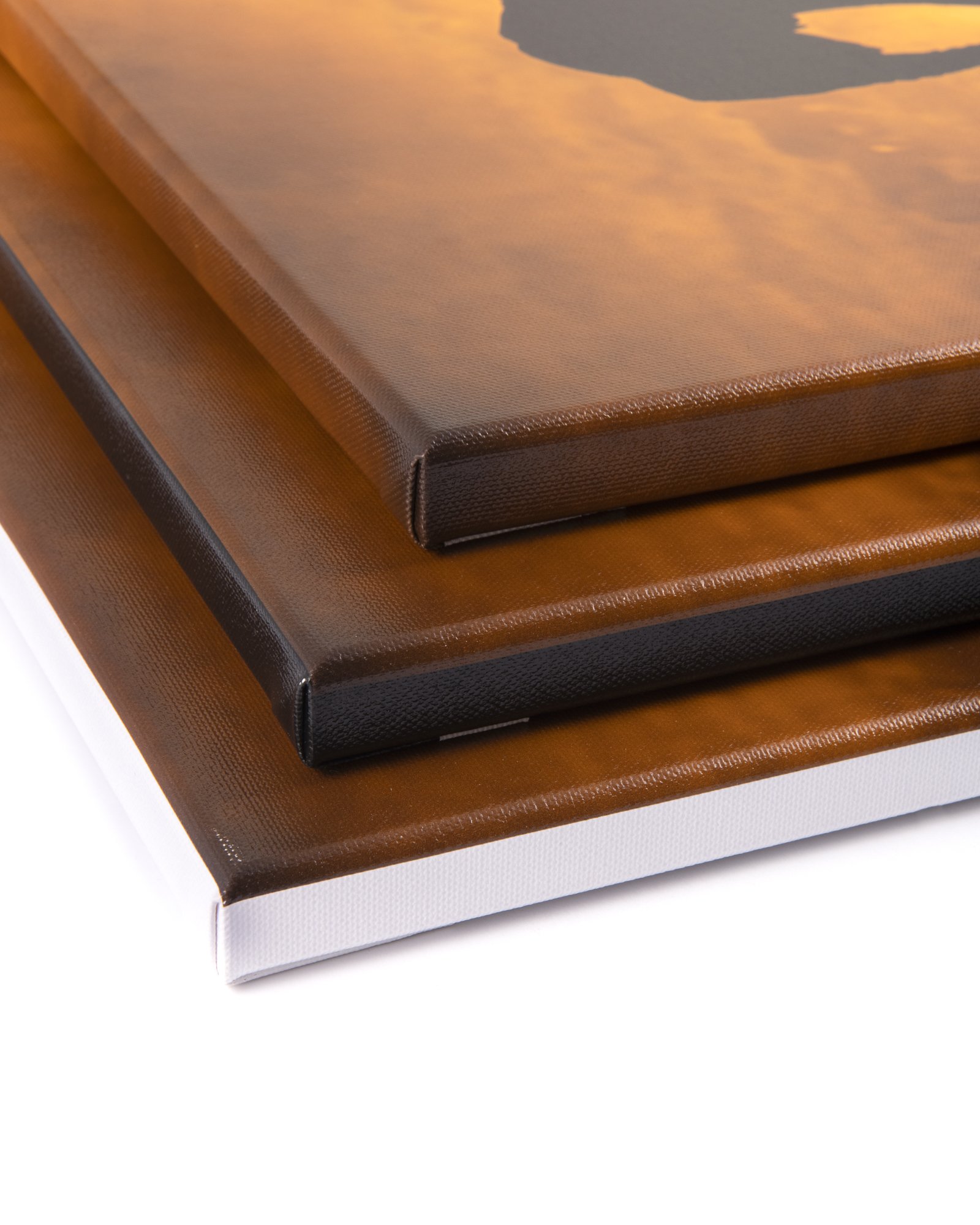 Close-up of three photo frames stacked on top of each other, featuring brown, black, and white borders.