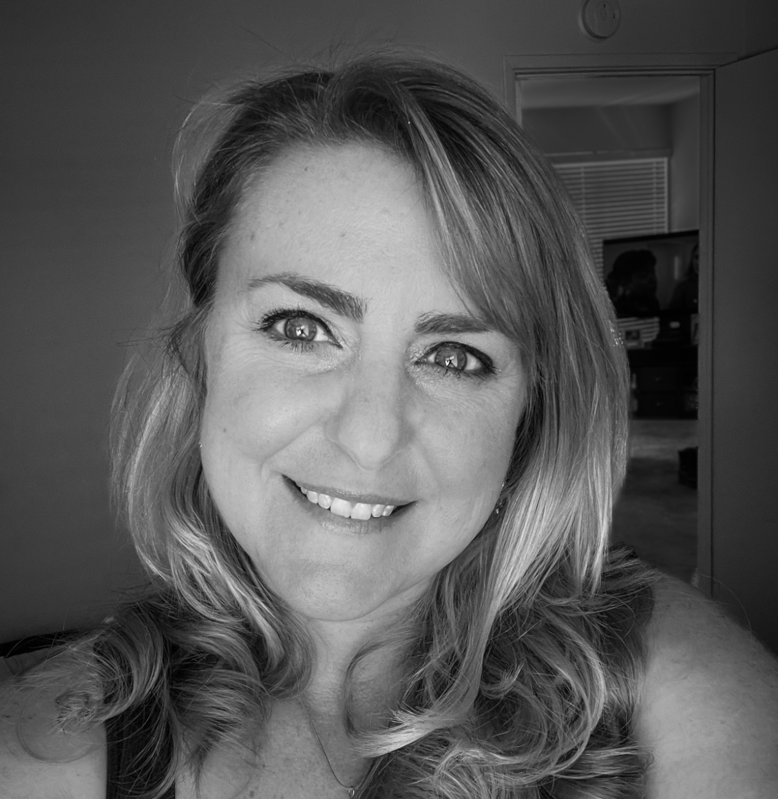 Portrait of Harmony Shipp, accounting and HR team member, smiling in a black and white photograph.