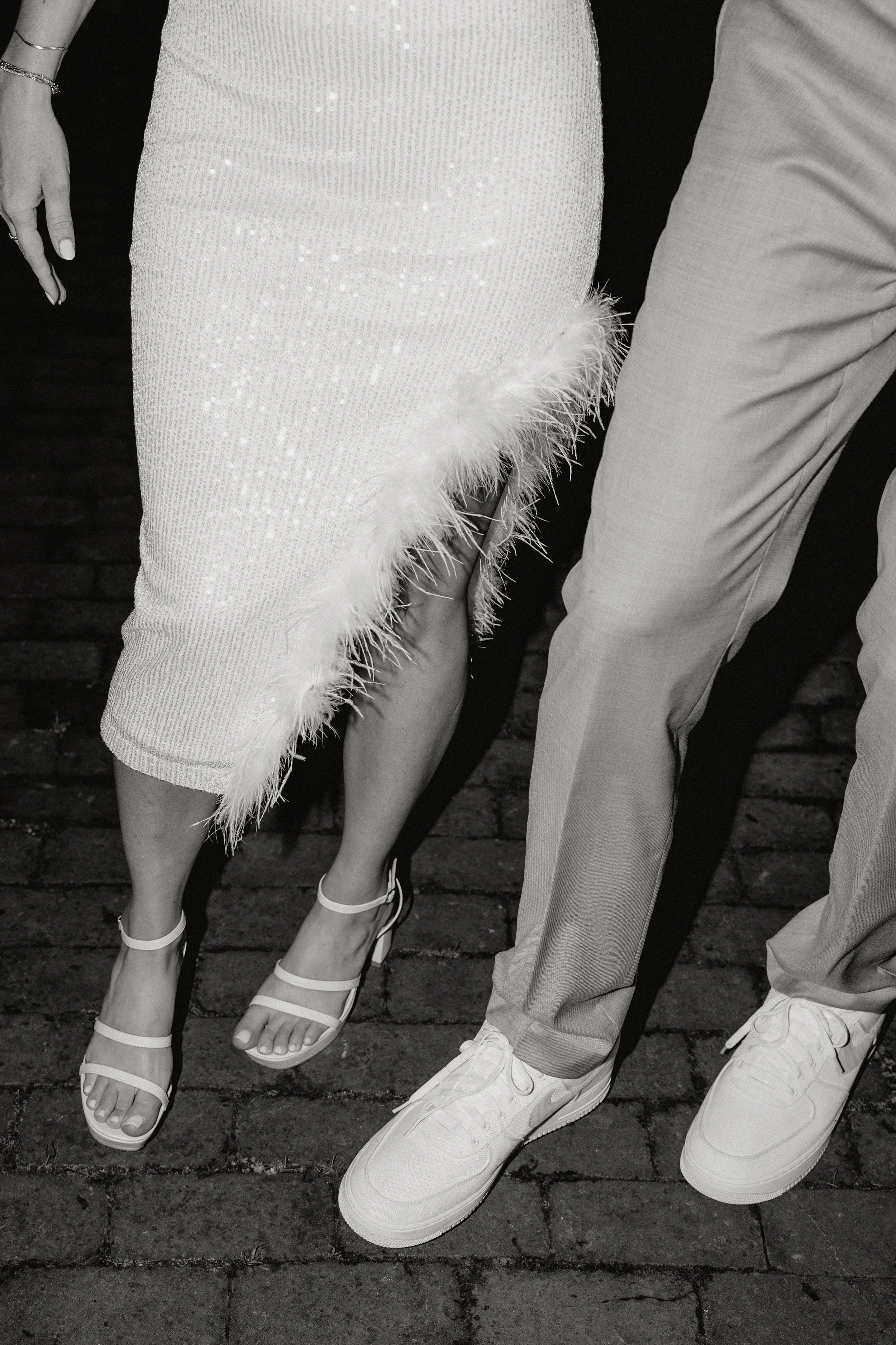 Close-up of two people standing on a cobblestone street at their wedding in Somerville, New Jersey photographed by Dominique Paulette Photography