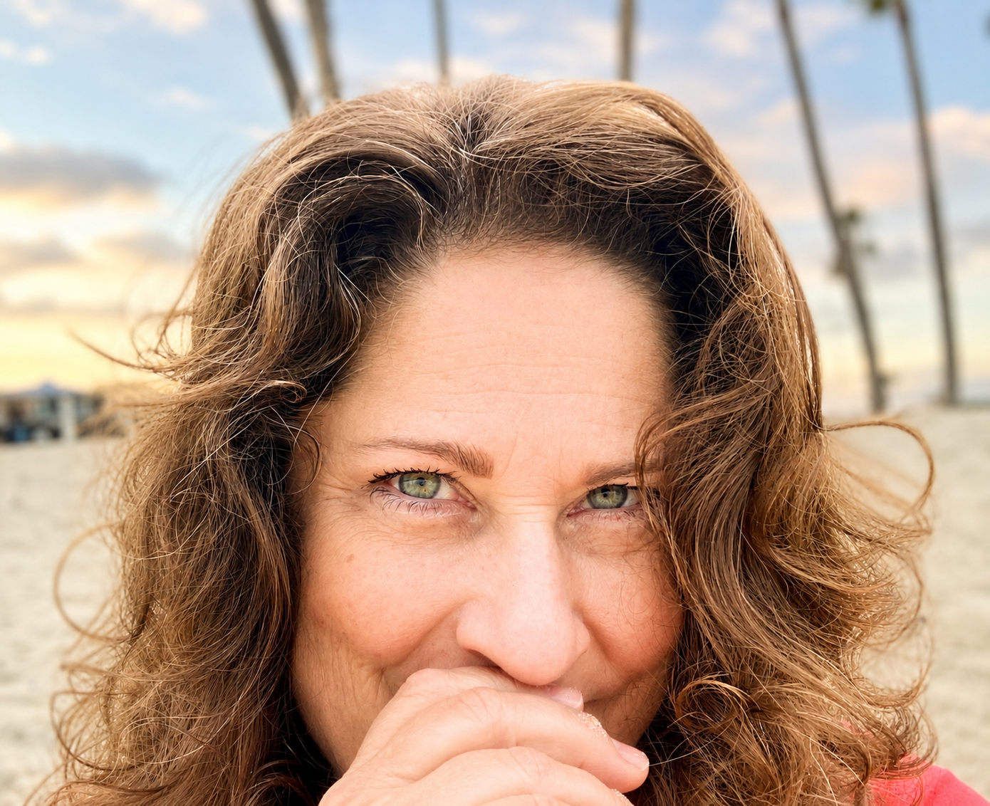 Woman with green eyes smiling into the camera close up