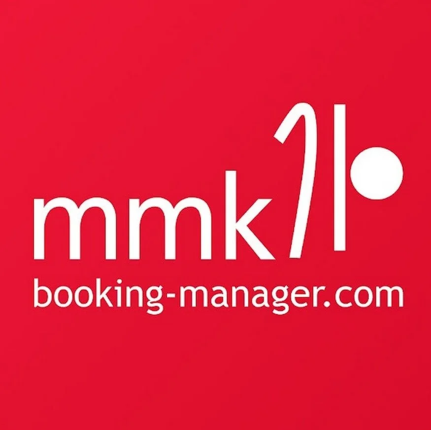 Red background with white text displaying 'mmk' with a stylized exclamation mark and a dot, and the website 'booking-manager.com'