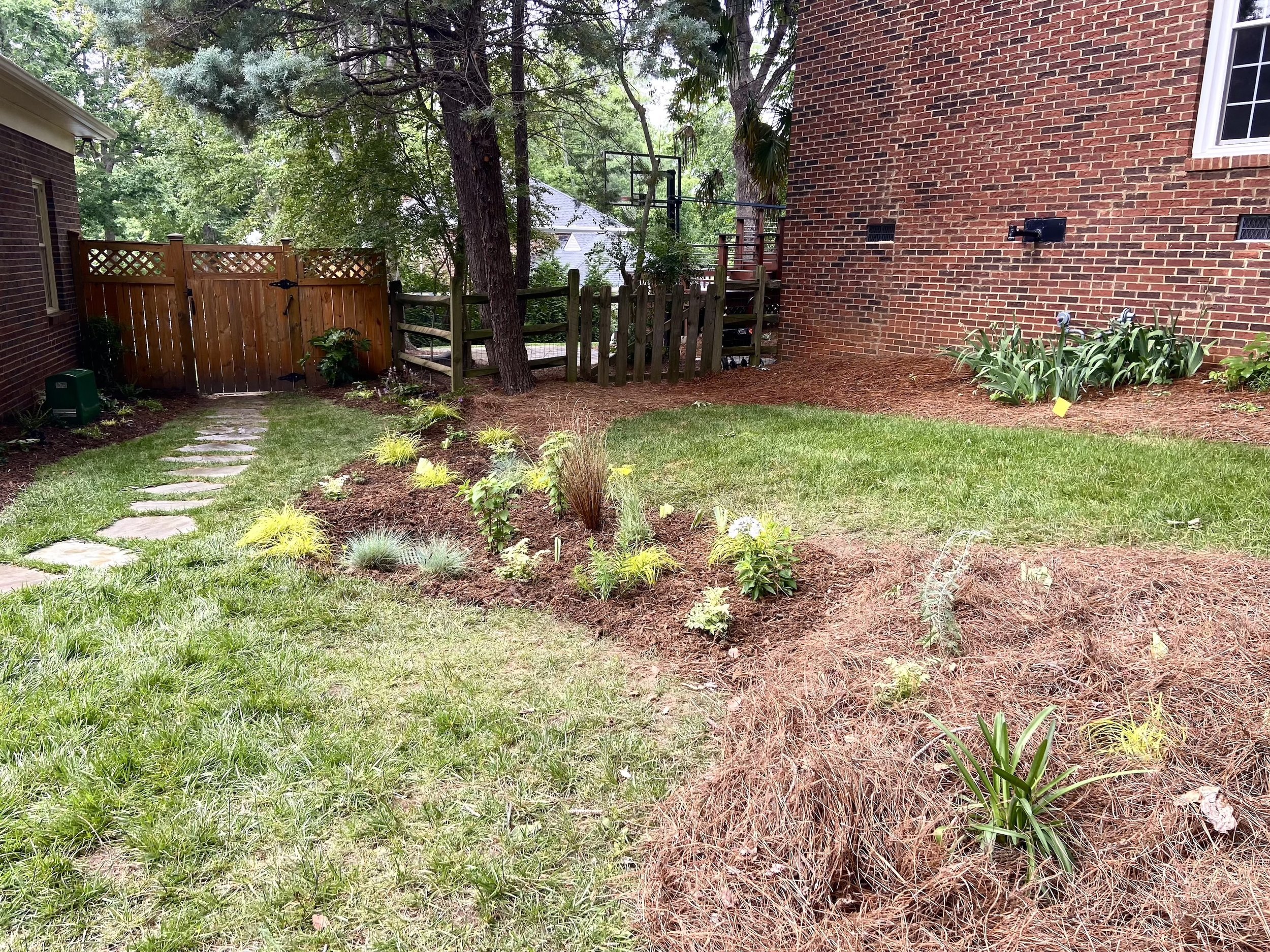 An organically shaped bed follows a natural flow to a drain.