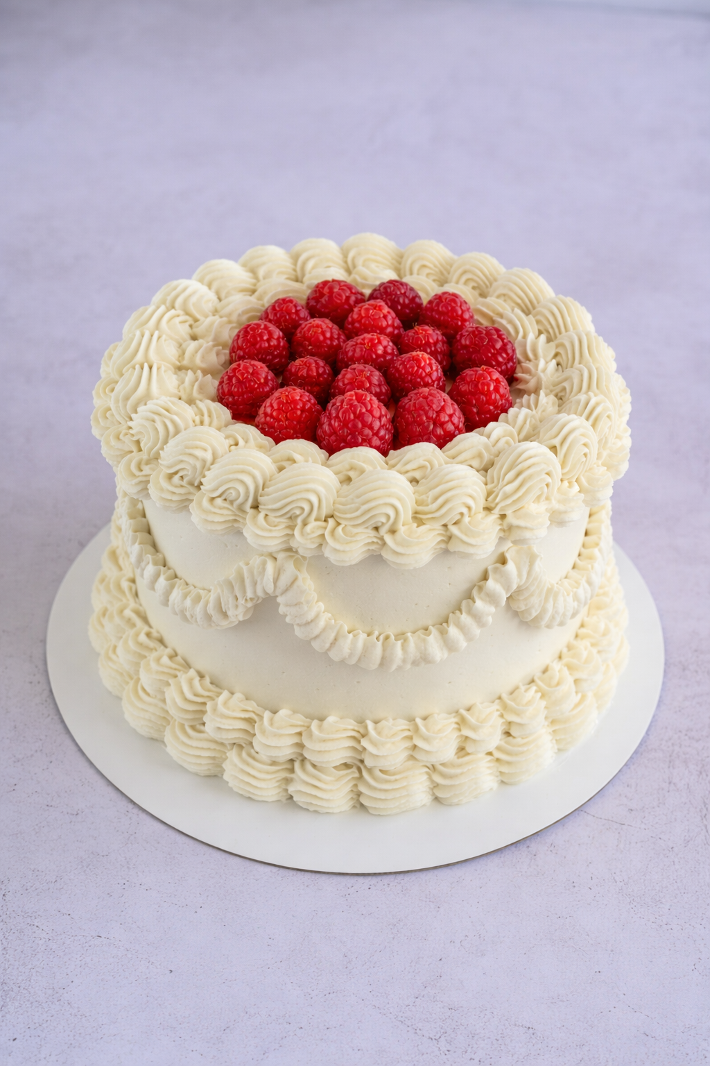 White vintage mini cake with raspberries