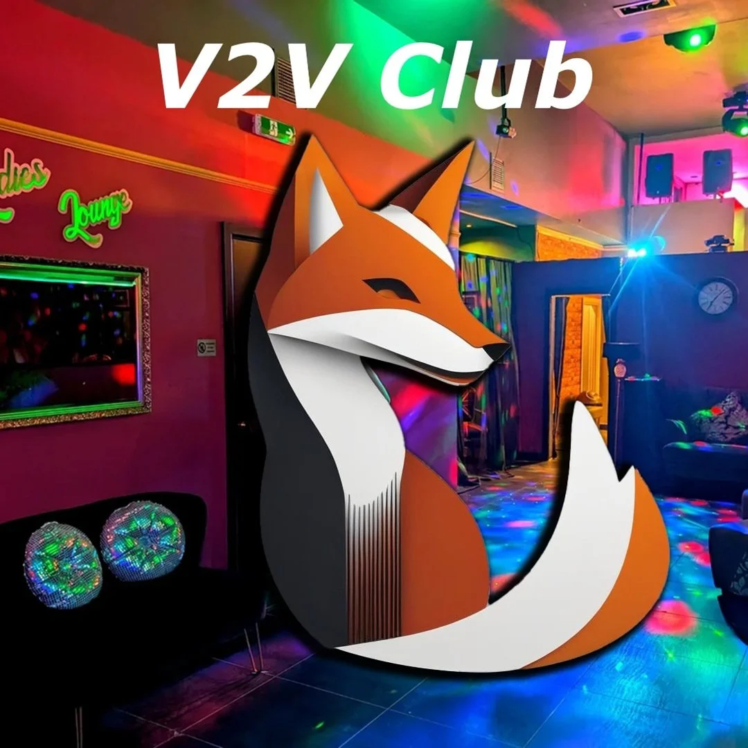 Colorful indoor club scene with a large fox logo and the text 'V2V Club' at the top.