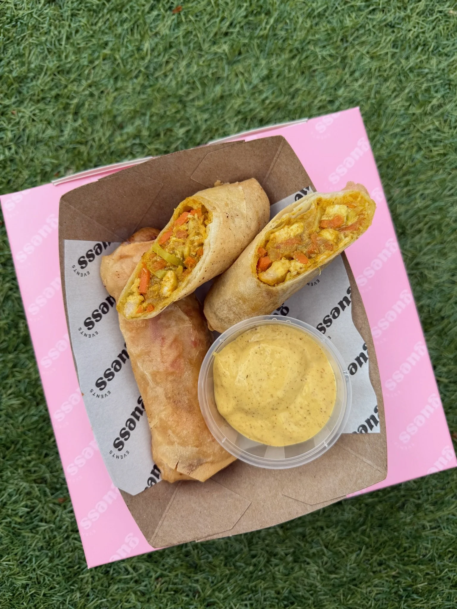 Two katsu curry crispy spring rolls served with a katsu curry mayonnaise in guess events packaging.