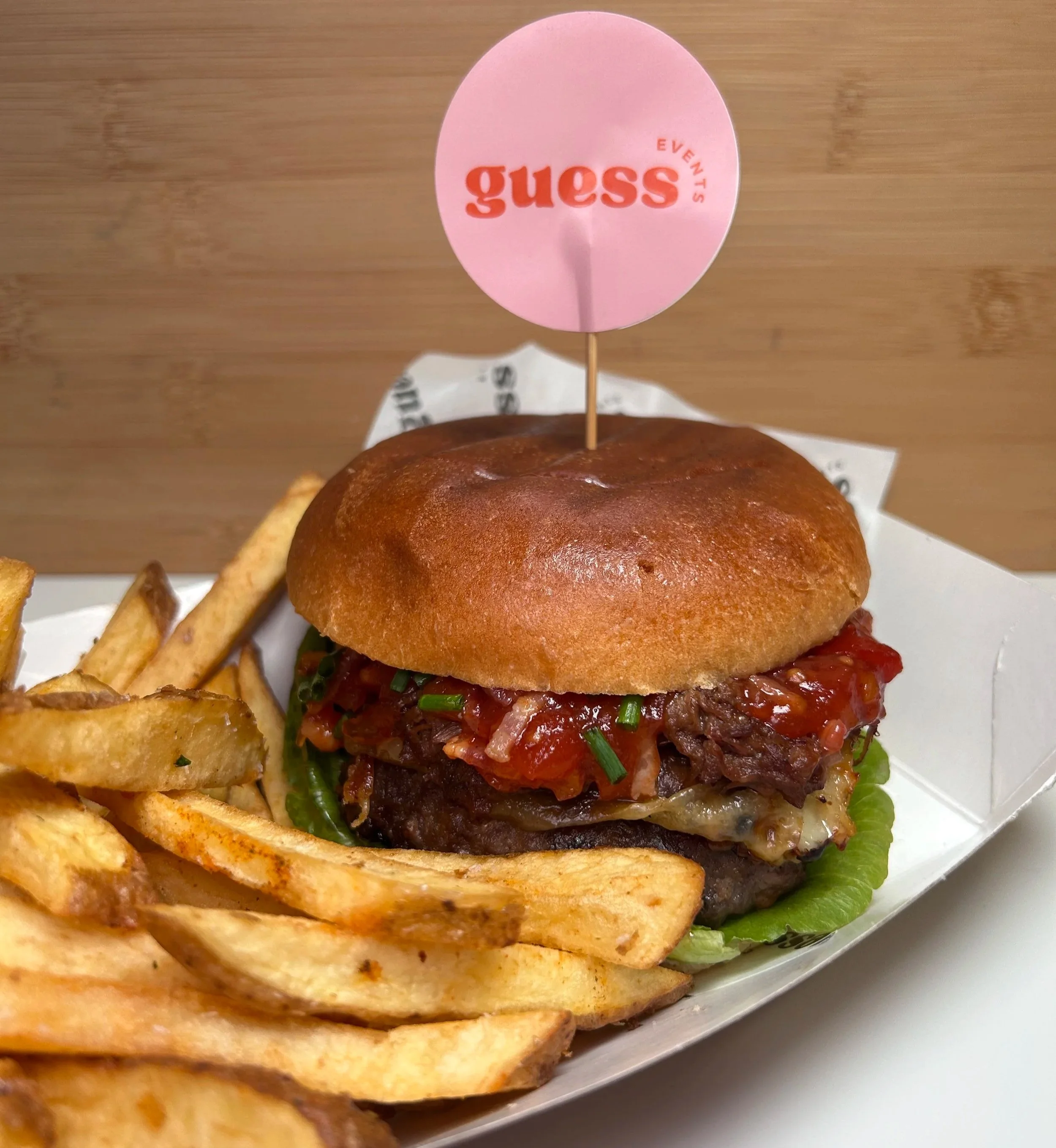 A loaded Guess Events crafted burger with seasoned hand-cut fries, served at the Guess Events food bar for weddings, corporate events, and parties across North Devon