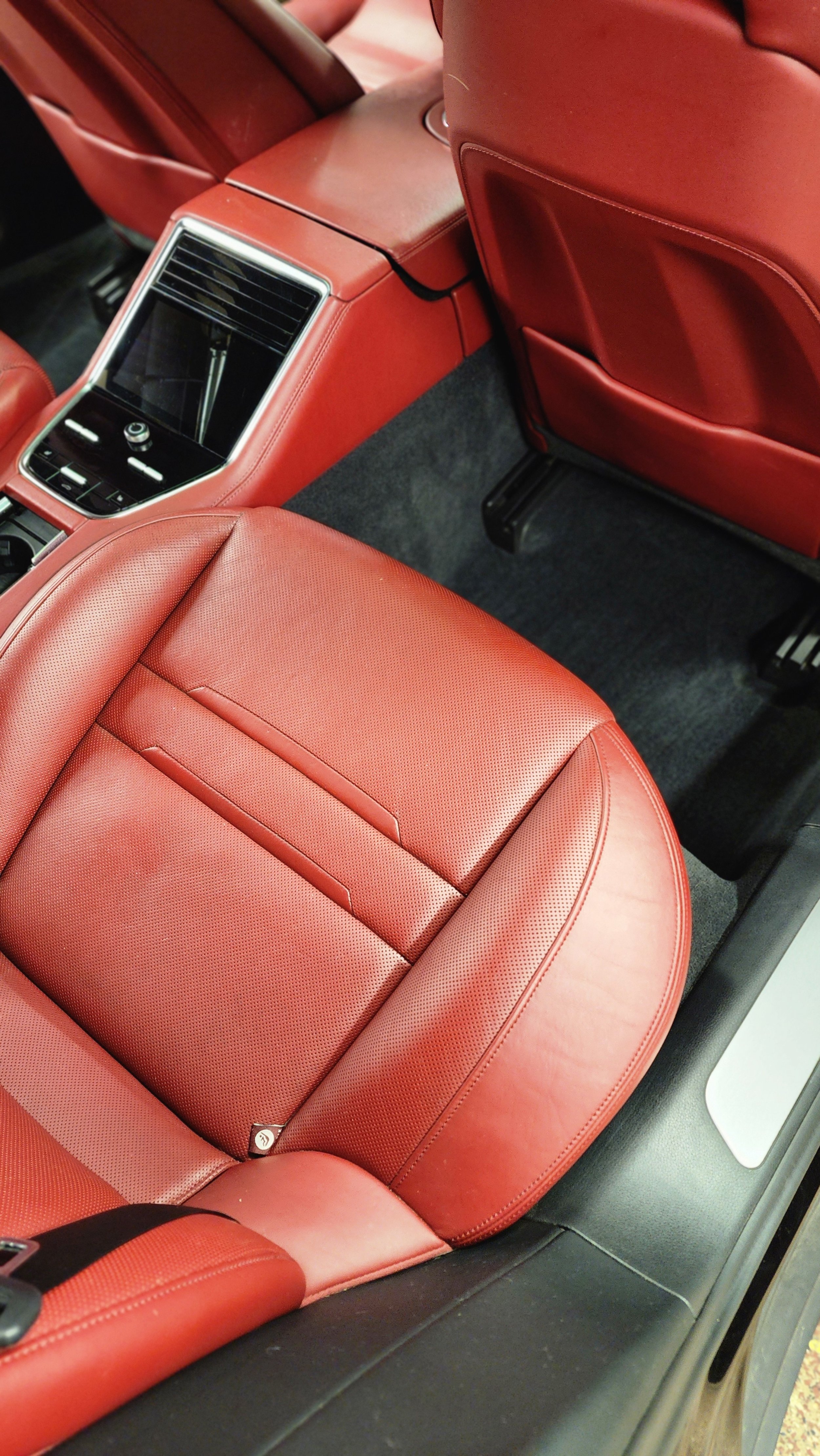 Red leather car seat and center console inside a vehicle