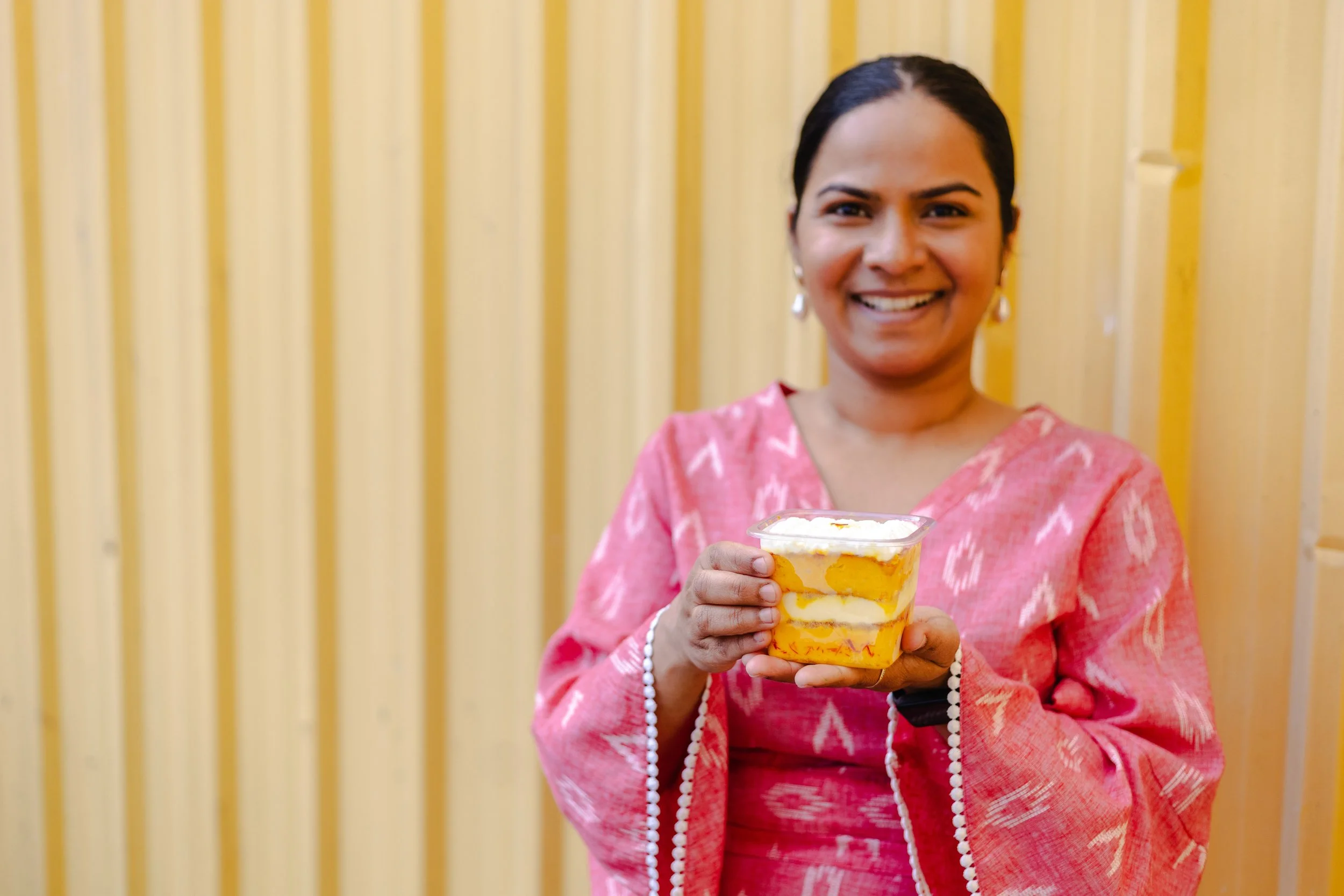 Owner Vinaya holding Rasmalai cake