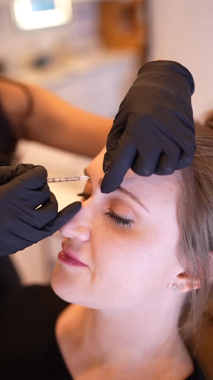 Gail Torres, founder of Anyo Aesthetics med spa in Scottsdale, AZ, administering a neuromodulator injection to a client’s brow area.