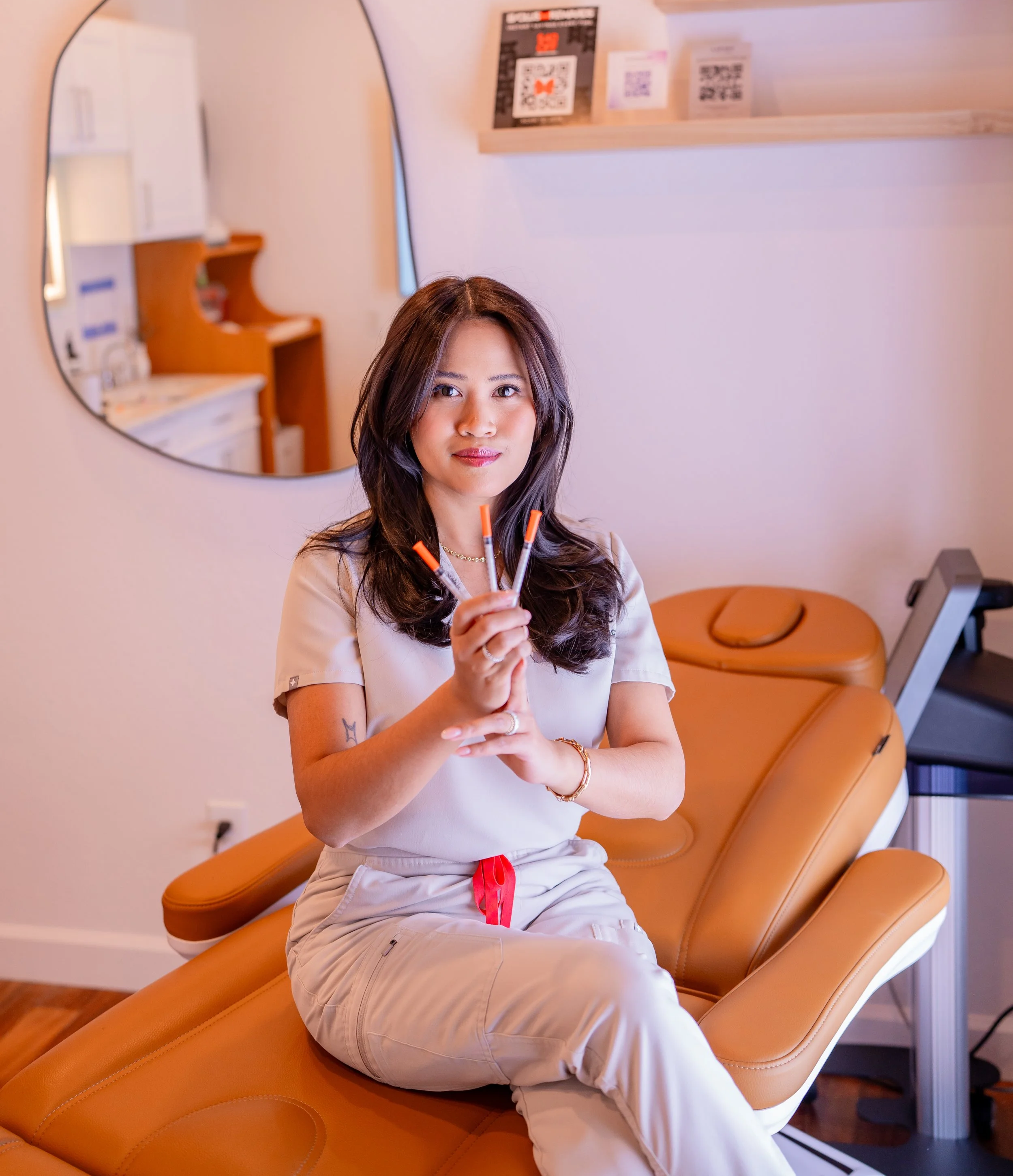 Gail Torres, founder of Anyo Aesthetics, with aesthetic injection tools in treatment room.