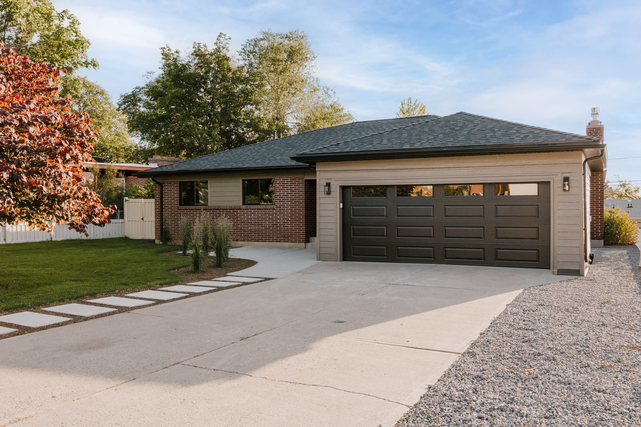 Well-maintained Utah home with mature trees, lawn, and two-car garage