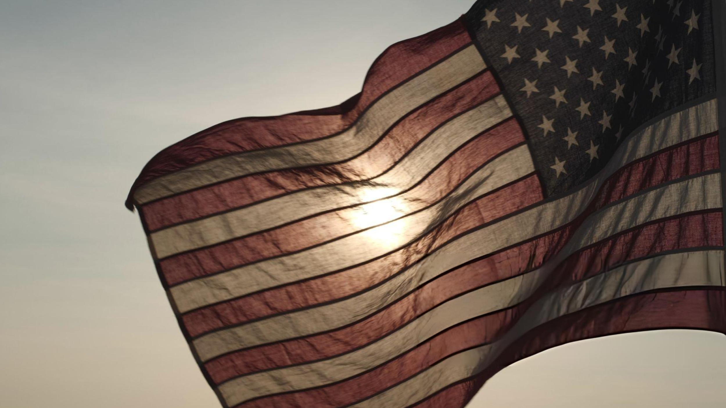 American flag waving at sunset symbolizing Memorial Day weekend travel in Utah
