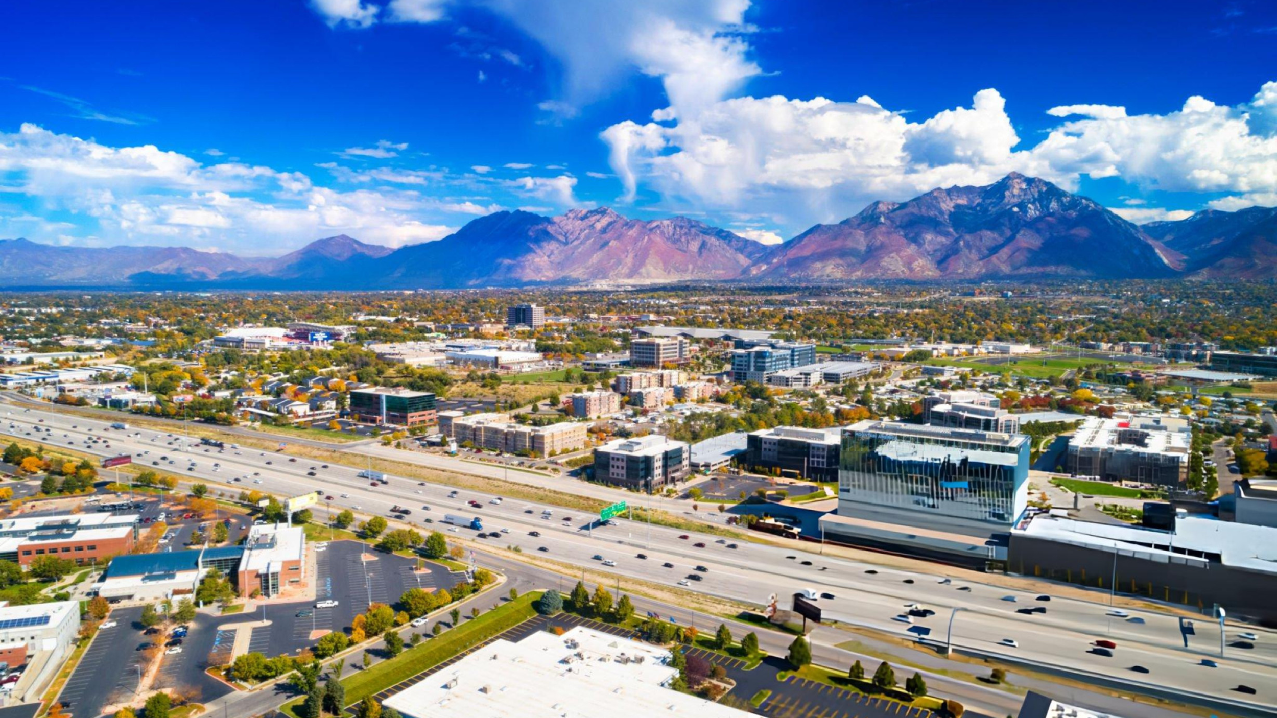 Panoramic view of Sandy, Utah showcasing the city skyline, mountain backdrop, and open skies, highlighting the lifestyle and natural beauty featured in Where Everyday Living Meets Open Sky: Life in Sandy.