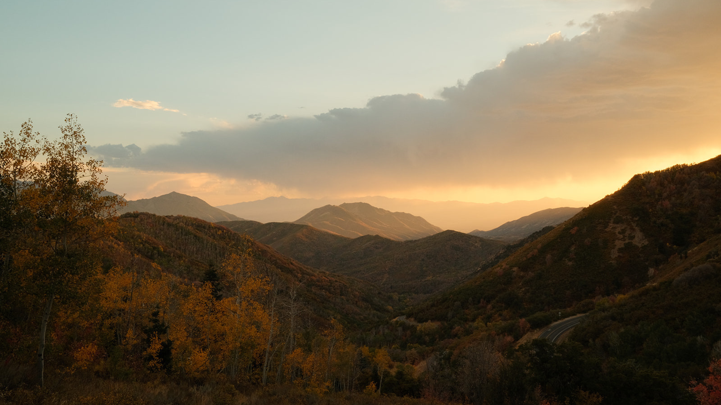 Golden sunset over Utah's mountain landscape, highlighting the natural beauty, outdoor access, and community lifestyle that make a neighborhood desirable beyond its school district.