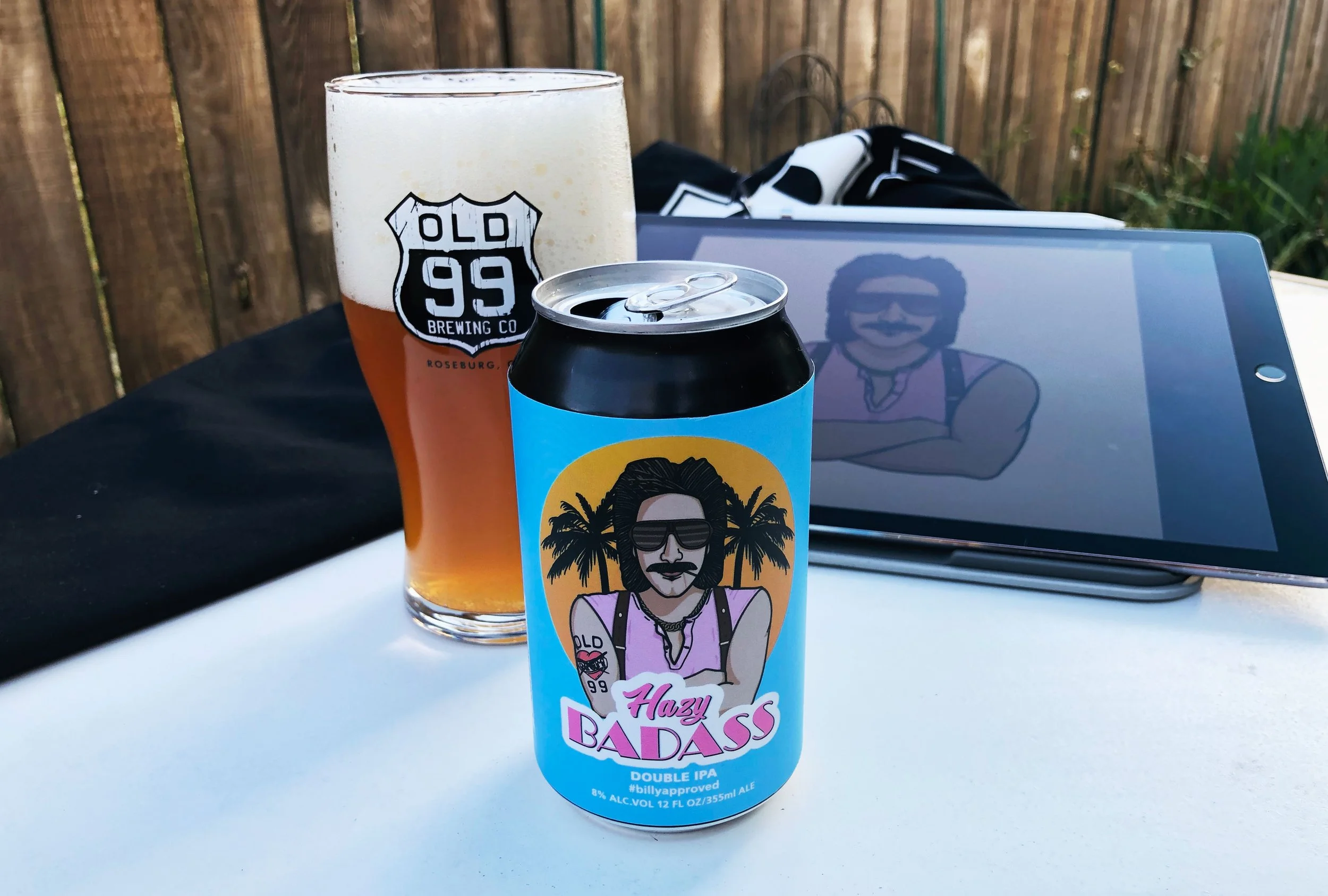 Old 99 Brewing Co Hazy Badass beer can with branded pint glass