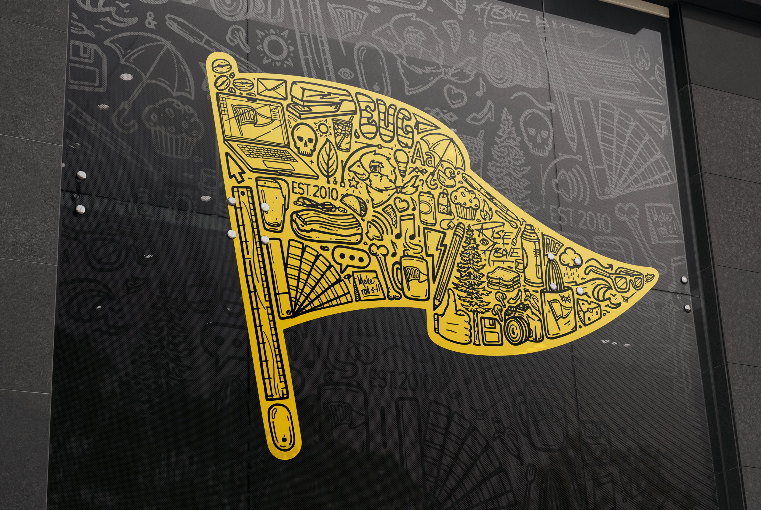 Large window or wall installation featuring gold Revolution Design Group Iconoflage pennant on dark surface with subtle pattern background