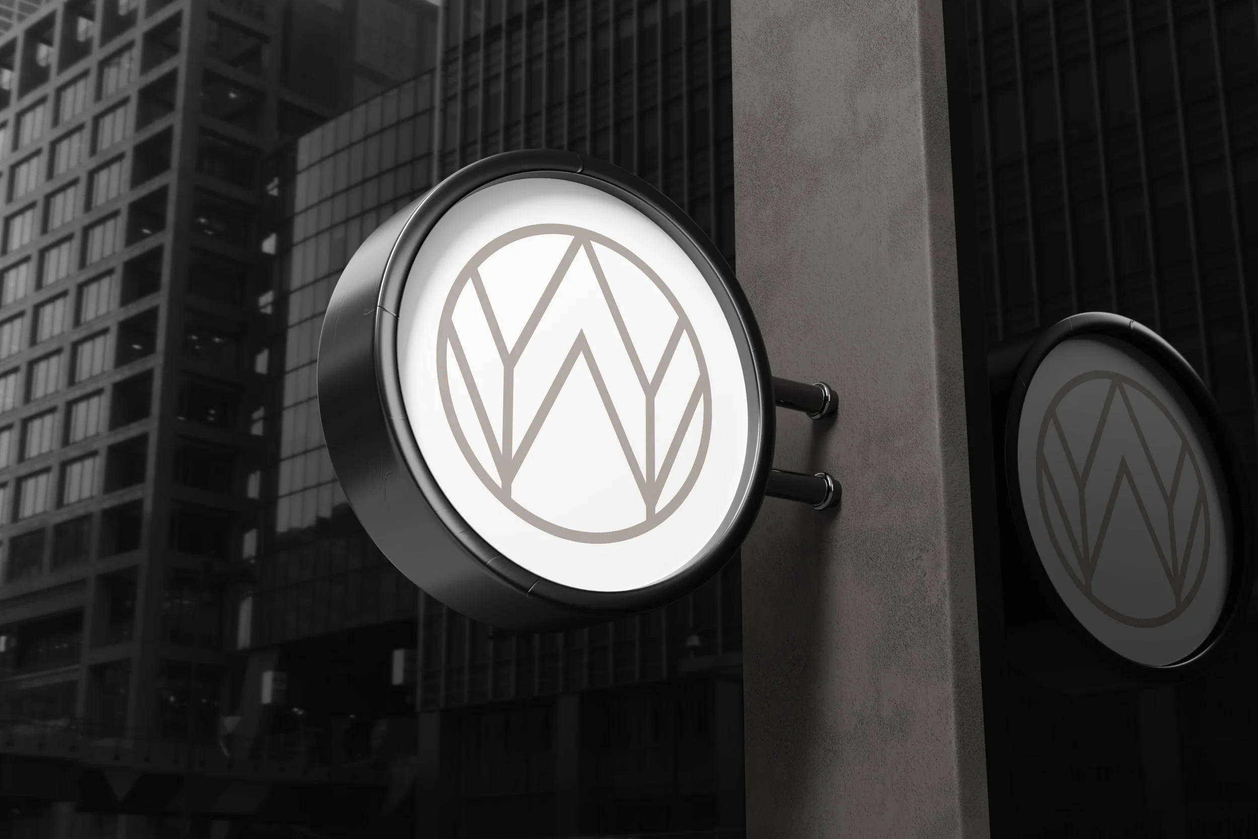 Circular blade sign with Whitewash Studio logo mark mounted on urban building exterior