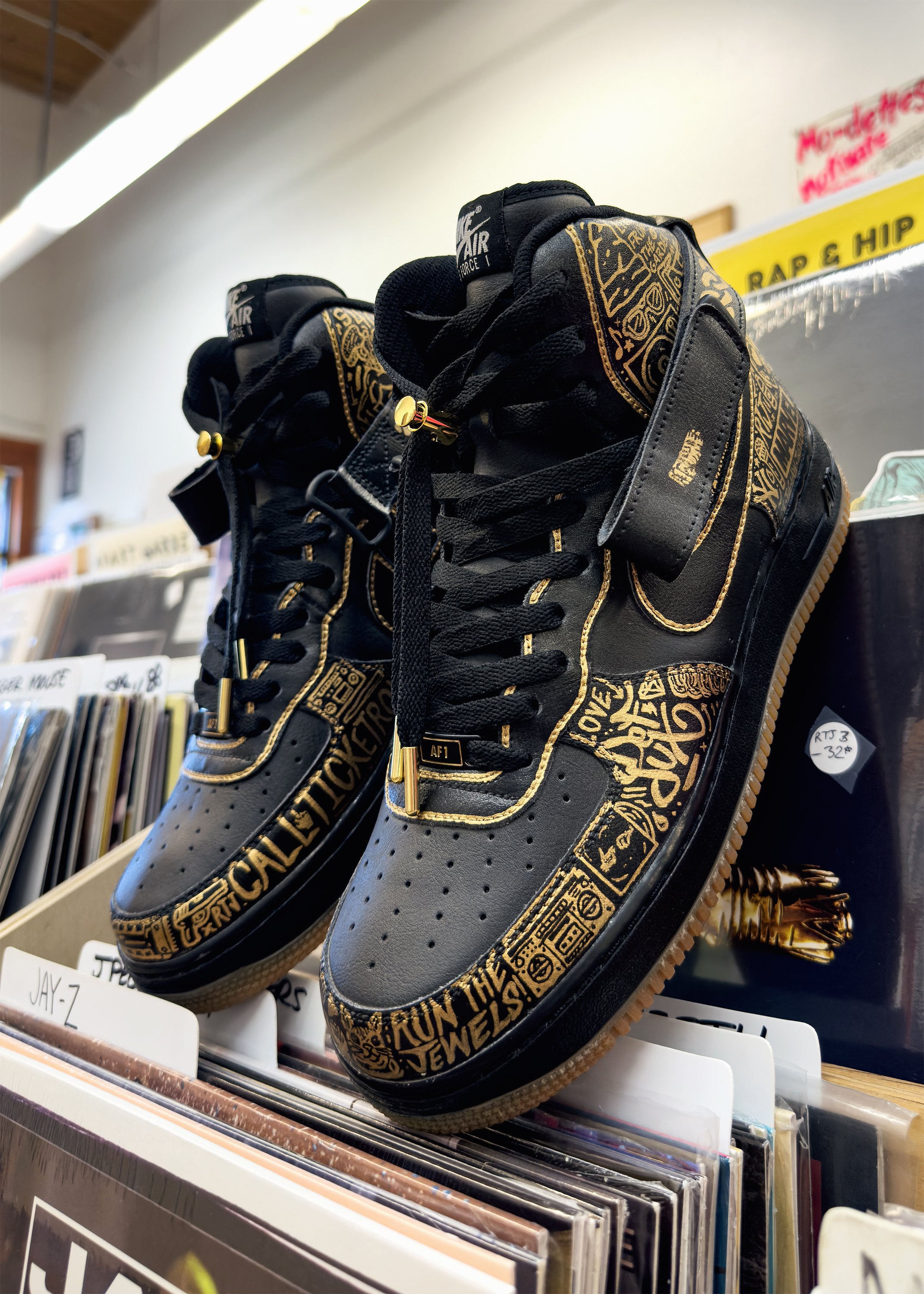 Run the Jewels custom Air Force 1 sneakers displayed in record store with vinyl records