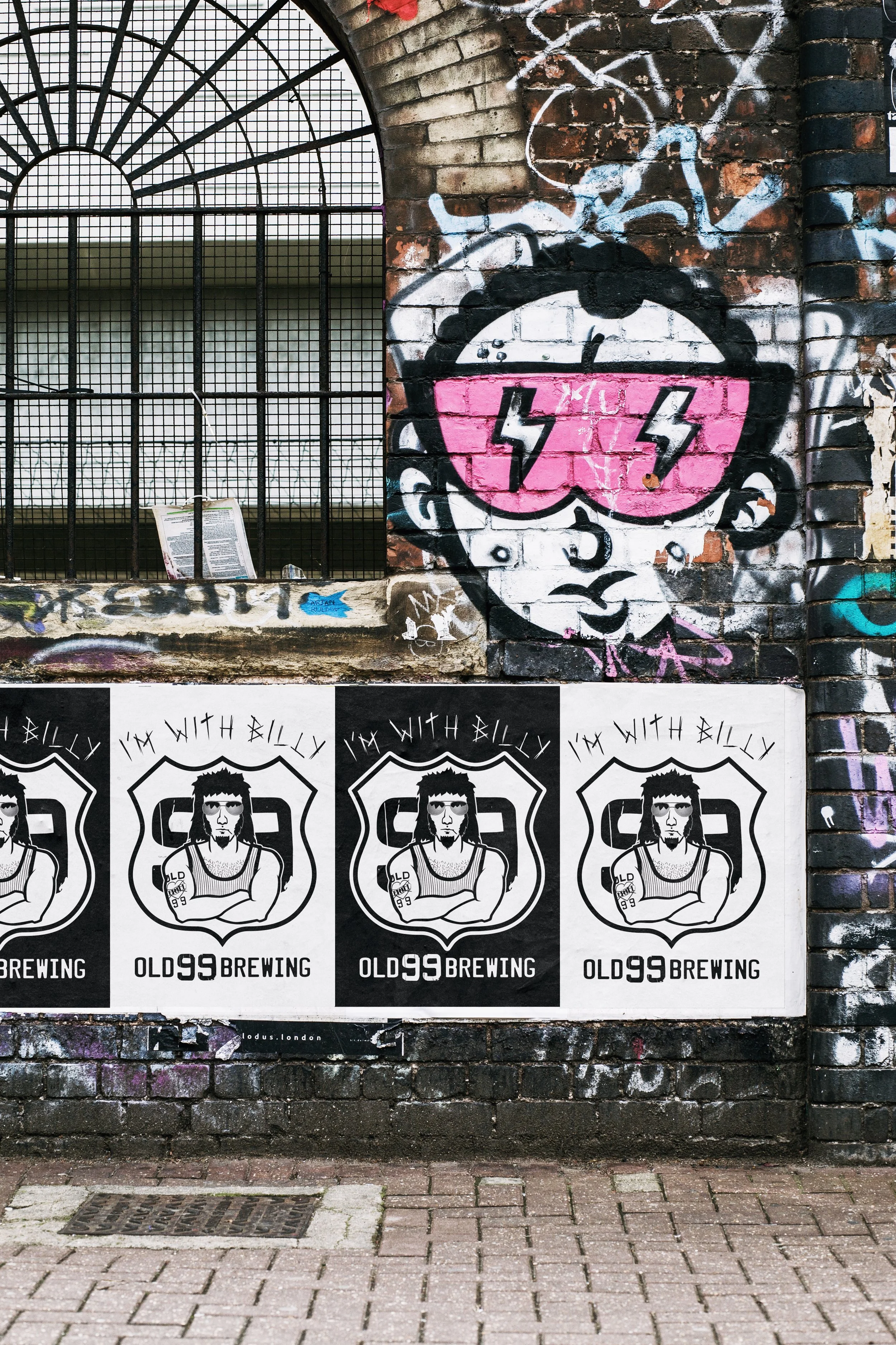 Old 99 Brewing Co I'm With Billy promotional posters on urban graffiti wall