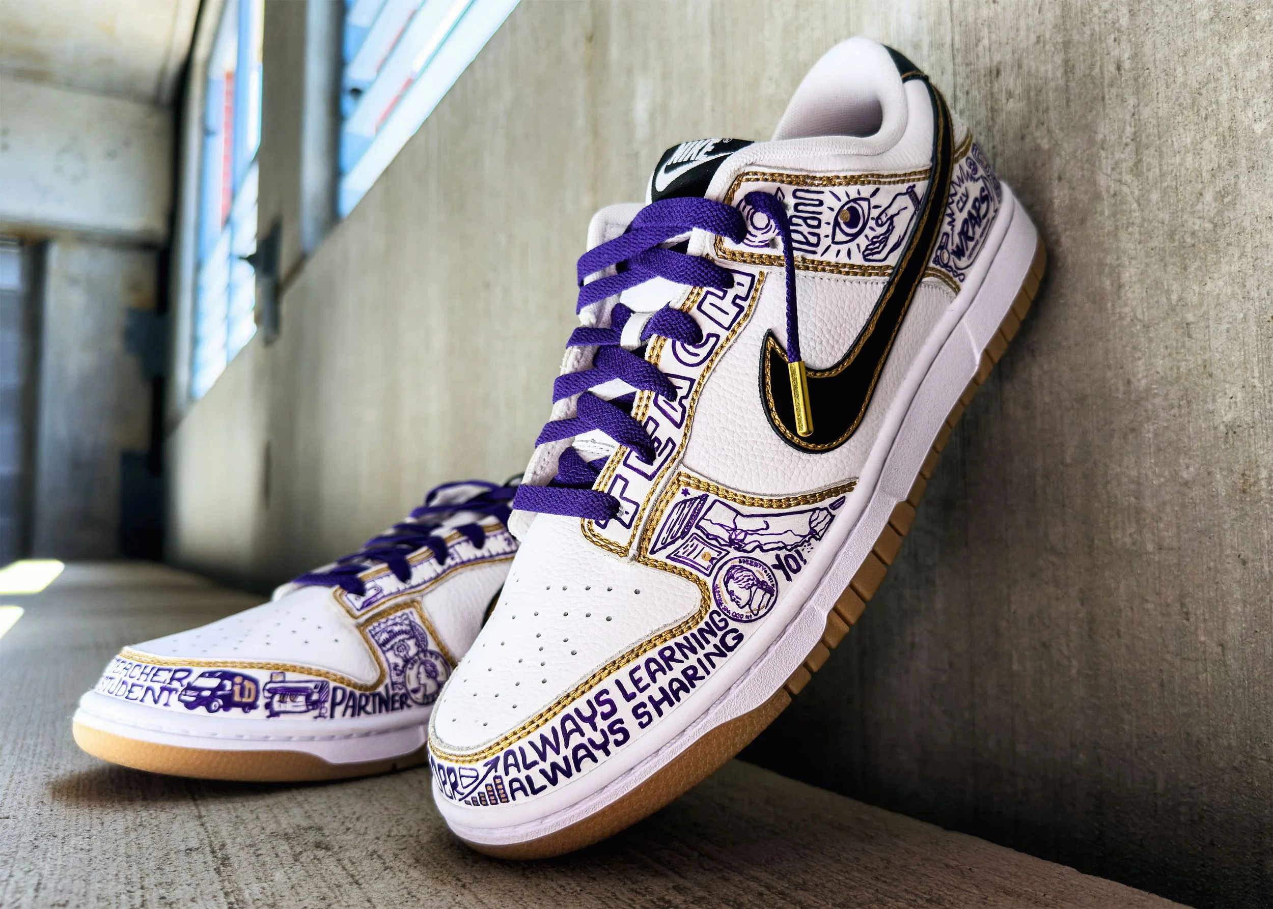 Close-up of custom Nike Dunk lateral side showing intricate hand-painted icons celebrating entrepreneurial journey