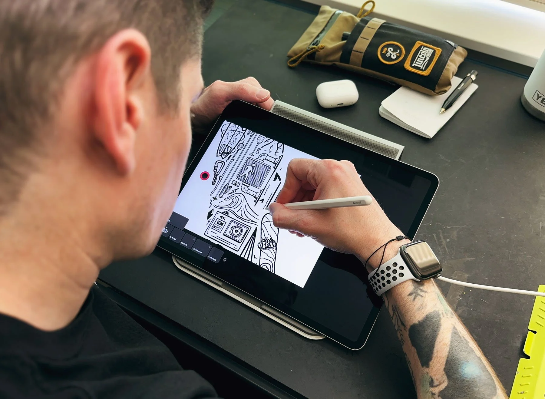 Scott Hofford drawing an outdoors theme black and white brand illustration on his iPad